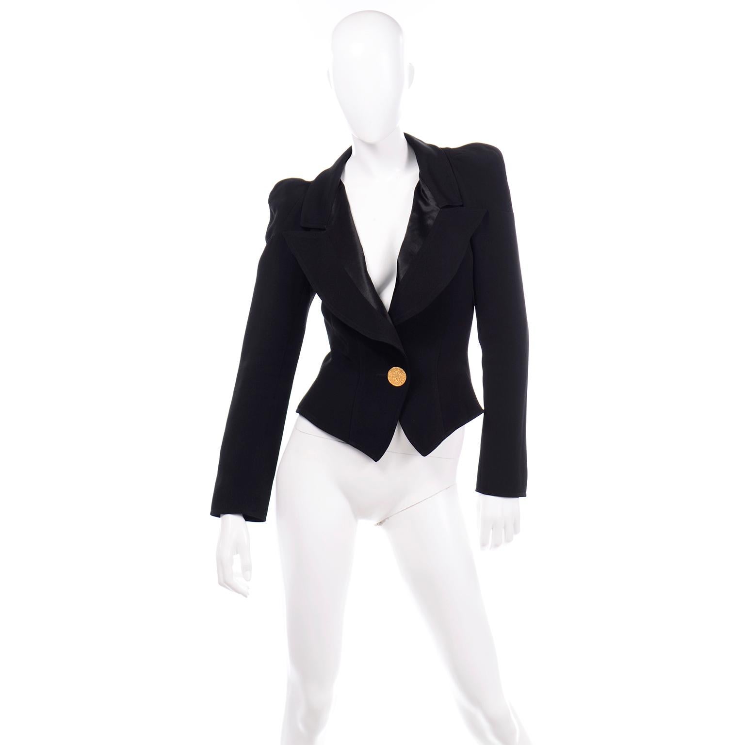 This incredible black vintage 1980's Christian Lacroix blazer would be perfectly on trend with a modern wardrobe! The jacket has gathered, puffed shoulders, which are structured with seams and small pleats. Half of the lapel has beautiful black