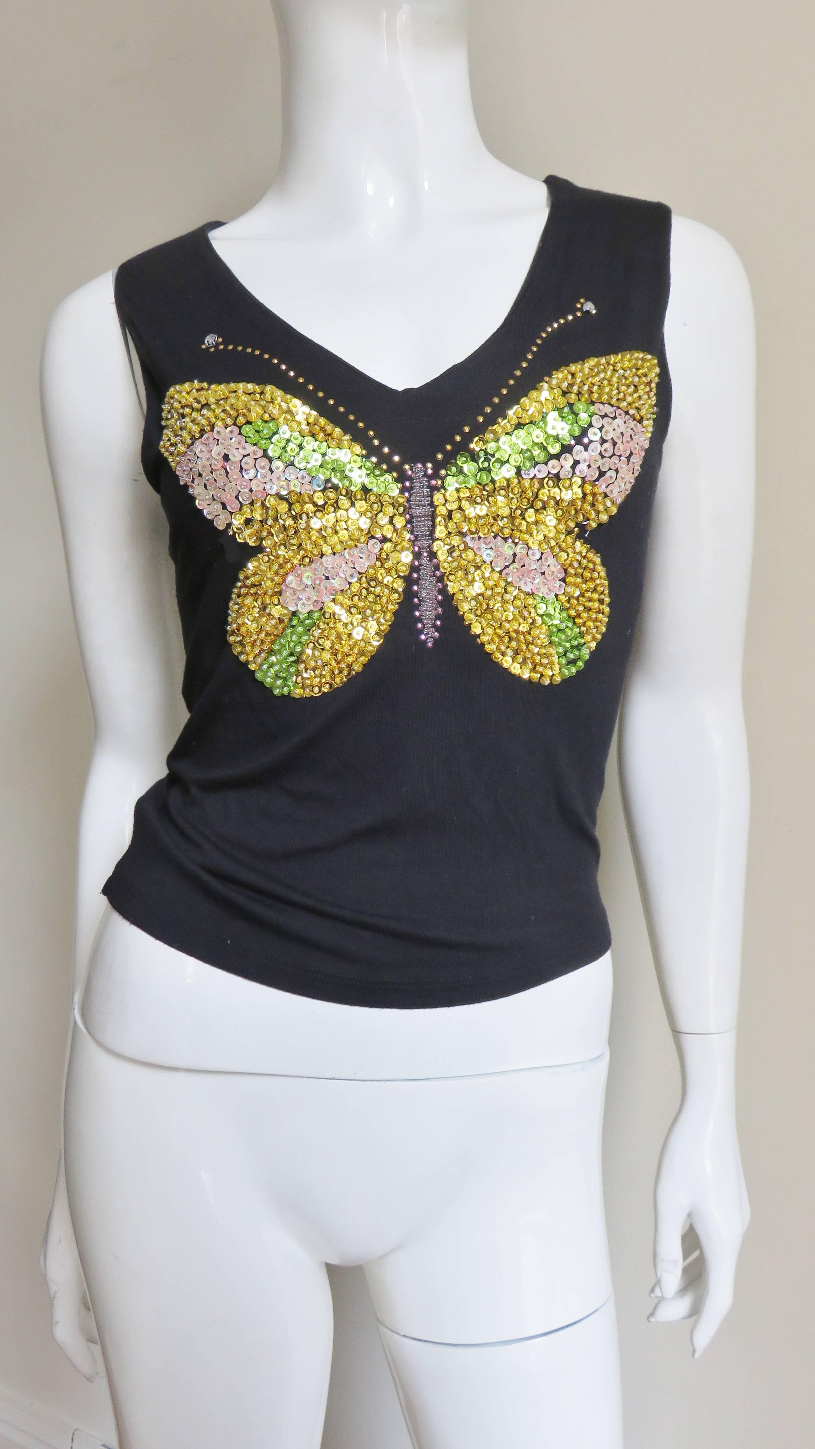 A fabulous black cotton t-shirt from Christian Lacroix.  It is sleeveless with a rounded V neckline and a beautiful sequin and beads butterfly in gold and green.   It has rhinestones at the antennae tips.  
Good Condition.  Fits sizes Extra Small,