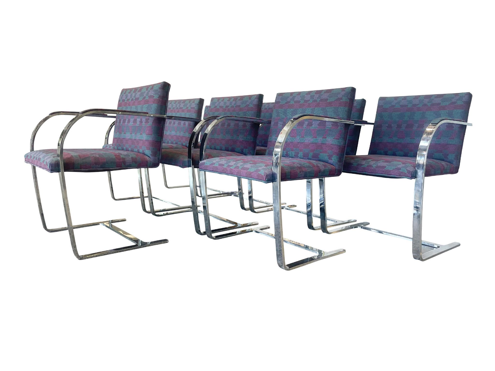This set consists of 8 chrome armchairs attributed to Ludwig Mies van der Rohe. Originally designed in the 1930s, the Brno chairs are iconic for their cantilever structure. They are flat-bar chrome. This set has a woven upholstery with a