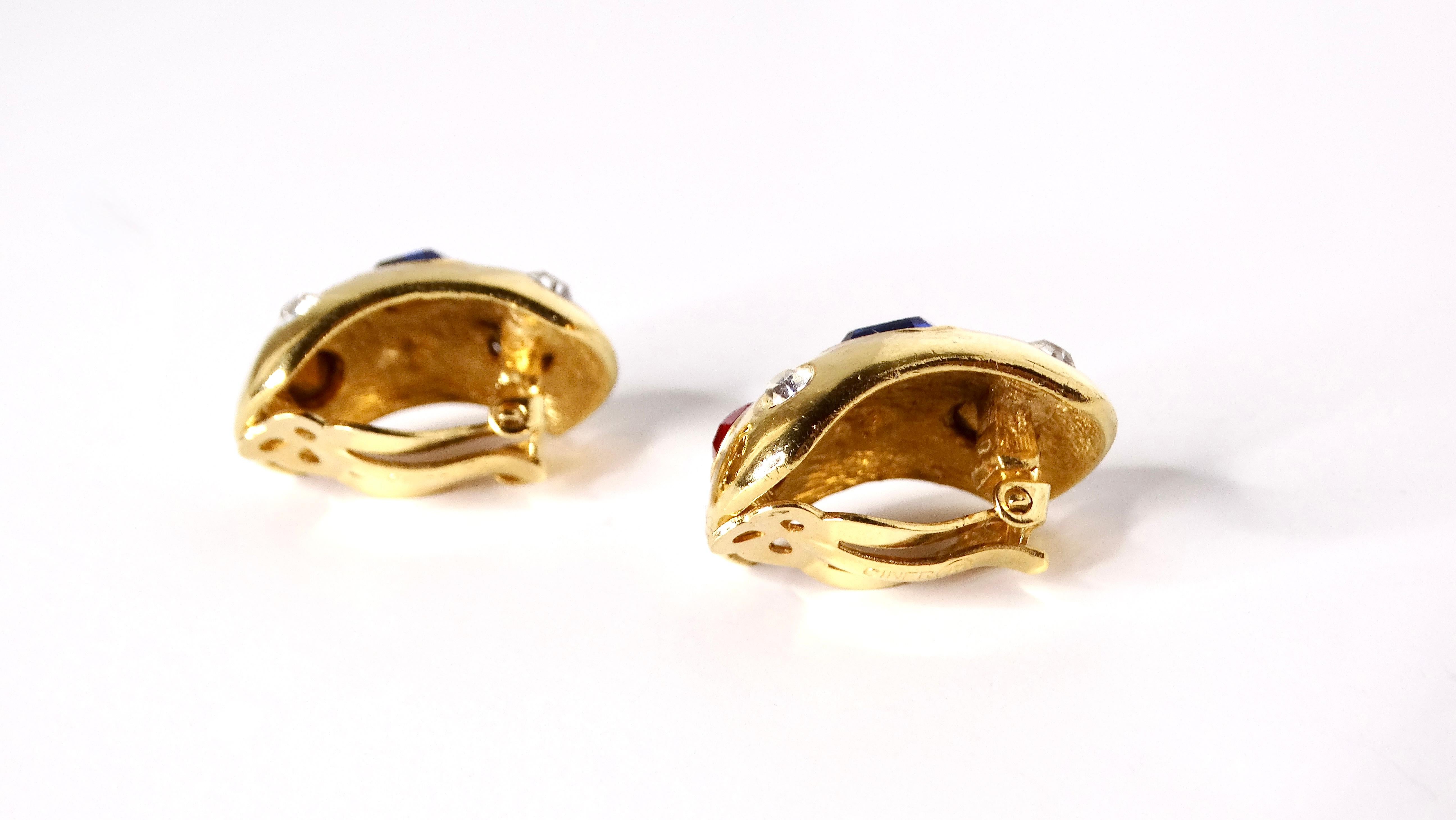 Step back into the vibrant fashion of the 1980s with these stunning Ciner Chunky Costume Gemstone Clip-On Earrings. Crafted with a tasteful design, each earring is adorned with several jewel-tone rhinestones, which capture the light beautifully and