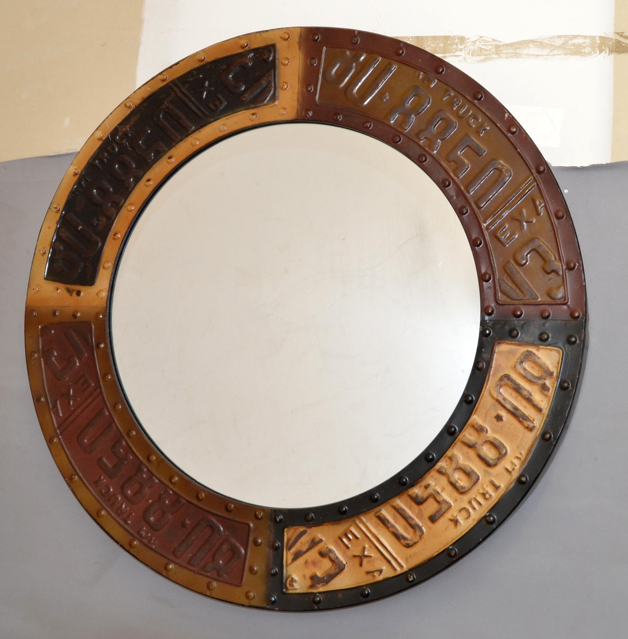 Mid-Century Modern Brutalist Style Round Metal Wall Mirror Texas Truck Theme in Hues of Brown on Black Finish.
Pop Art depicting parts of Texas License Plates squares.
Made in America circa 1980s.
A stunning Accent Mirror for a Boys Room, Man