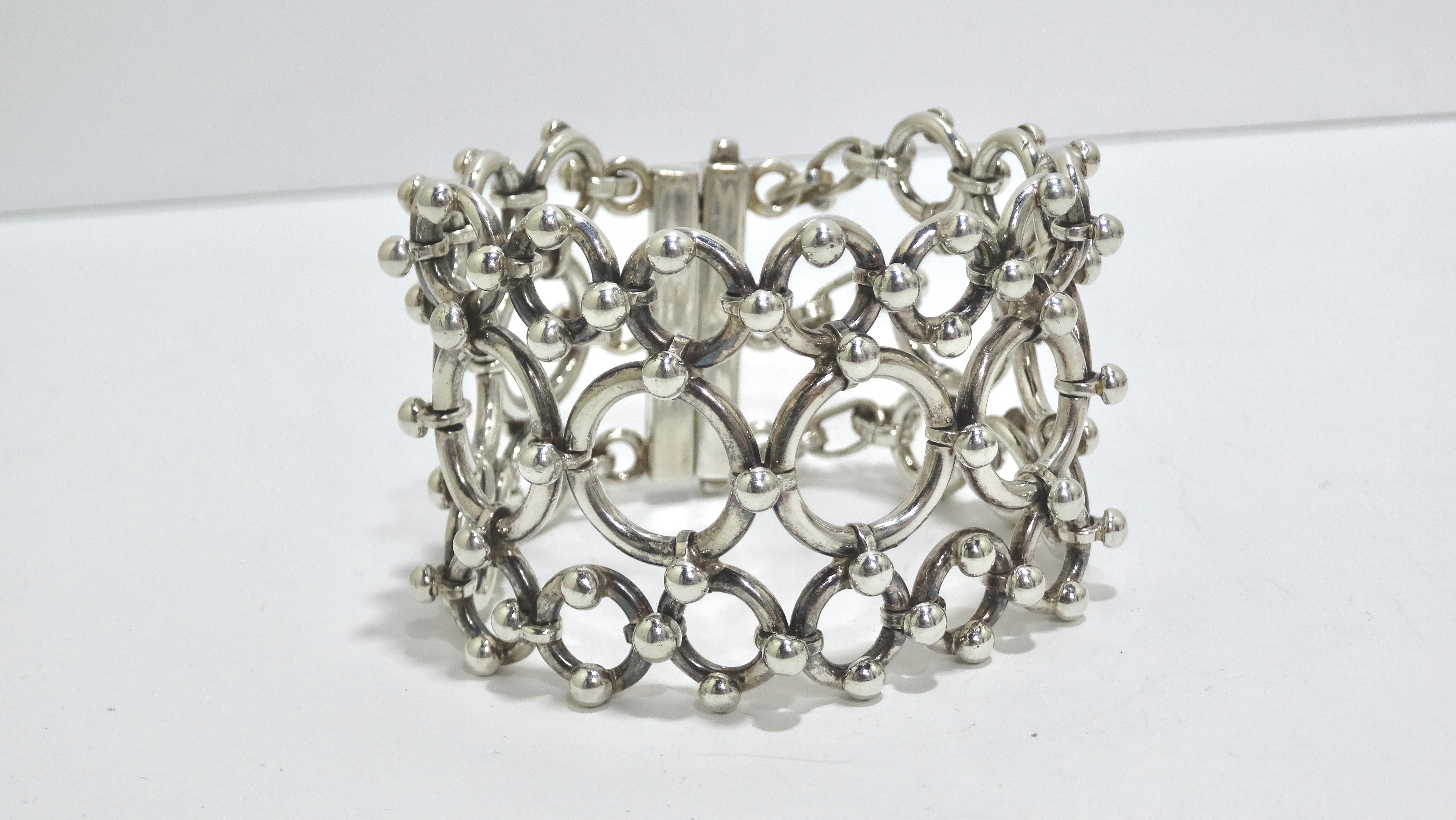 Your next statement bracelet has arrived! Right out of the 1980's, this necklace has bold geometrical detailing making up the whole bracelet. Varying sizes of circles are mended together to make a unique and beautiful piece of wearable art. Pair