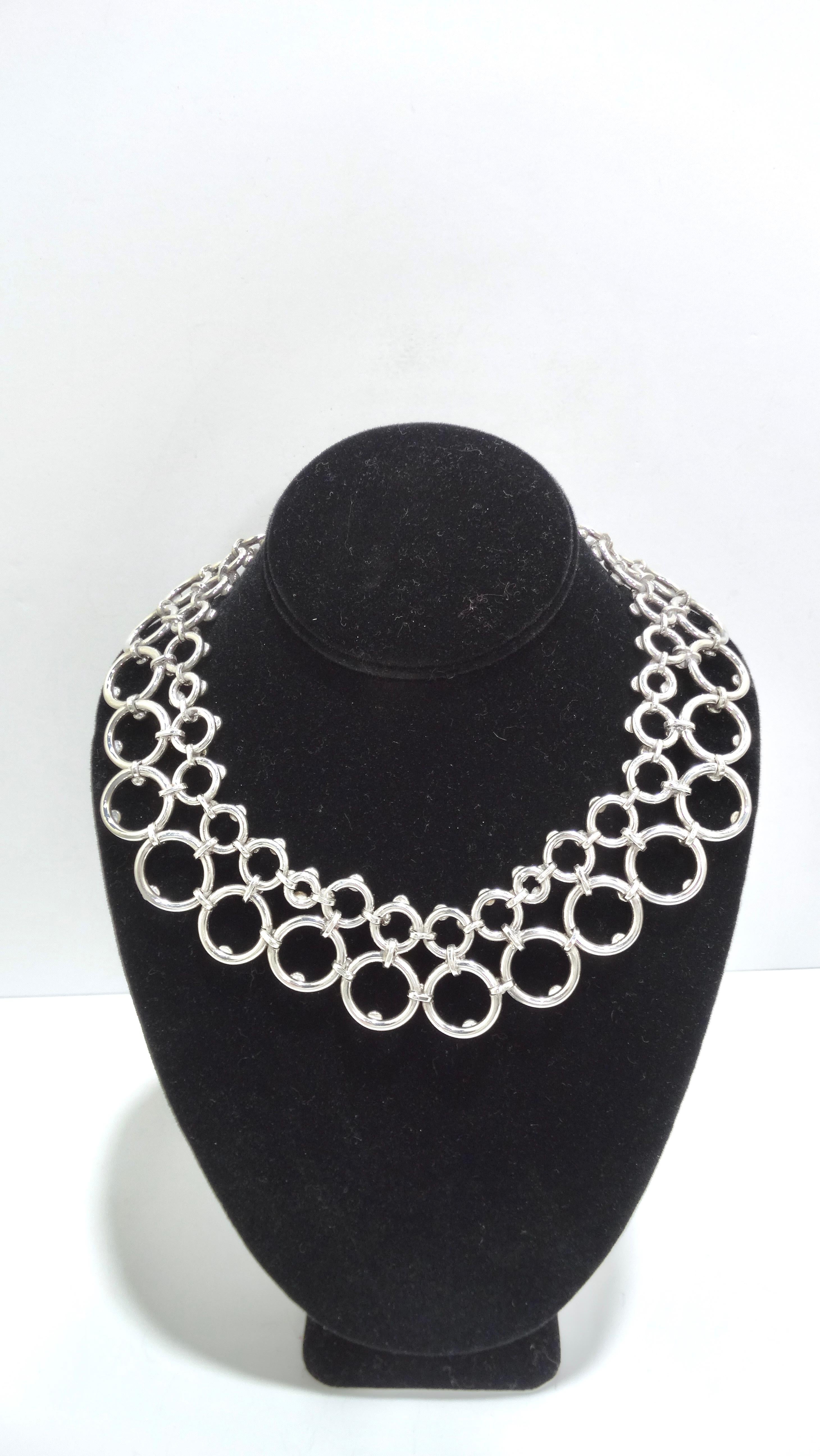 Your next statement necklace has arrived! Right out of the 1980's, this necklace has bold geometrical detailing making up the whole necklace. Varying sizes of circles are mended together to make a unique and beautiful piece of wearable art. Pair