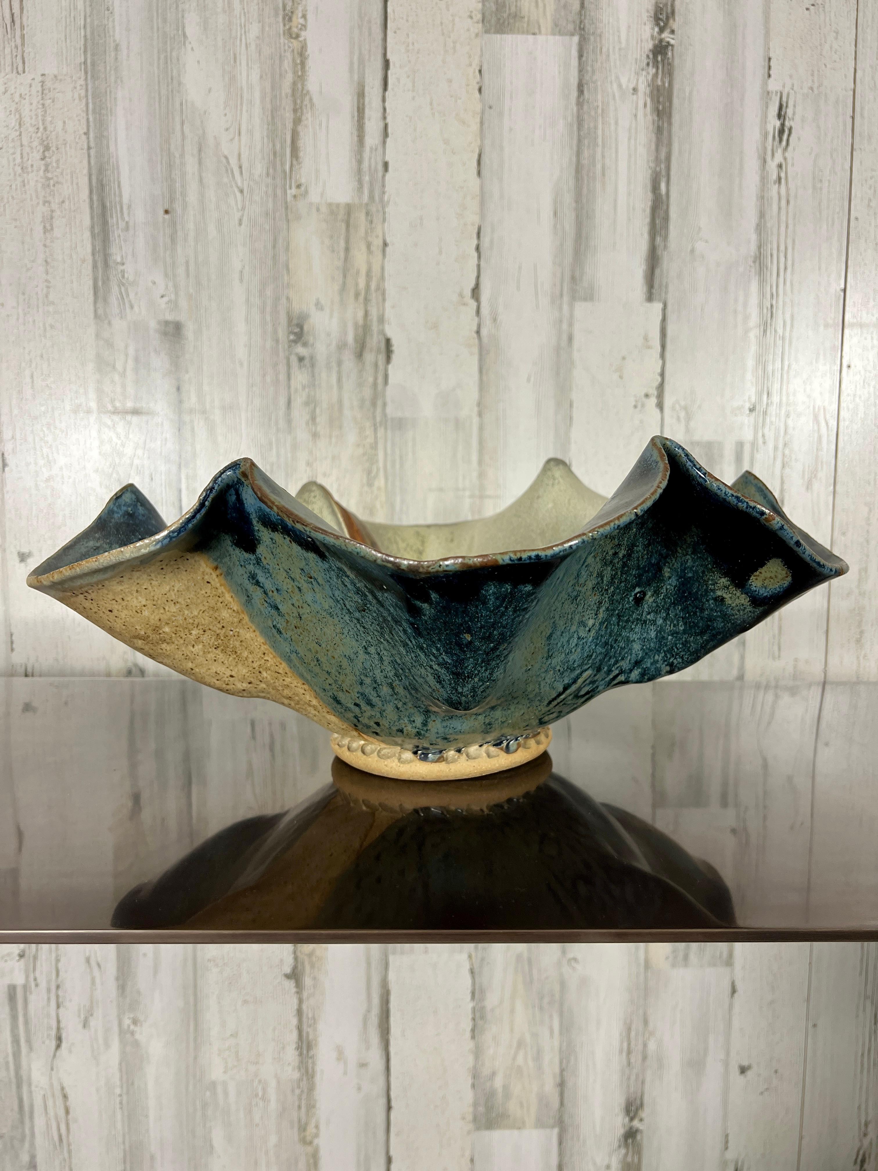 Multi-colored Post Modern clam shell design bowl with many different textures and patterns, some floral with repetitive design.