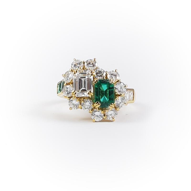 Typical 1980's italian - roman classical vintage ring, handmade in 18k gold with 1 emerald 0.75 carats, 1 diamond emerald cut 1 carat, 12 diamonds 0.80 carats, 2 baguette cut diamonds 0.20 carats, 2 emeralds 0.15 carats.