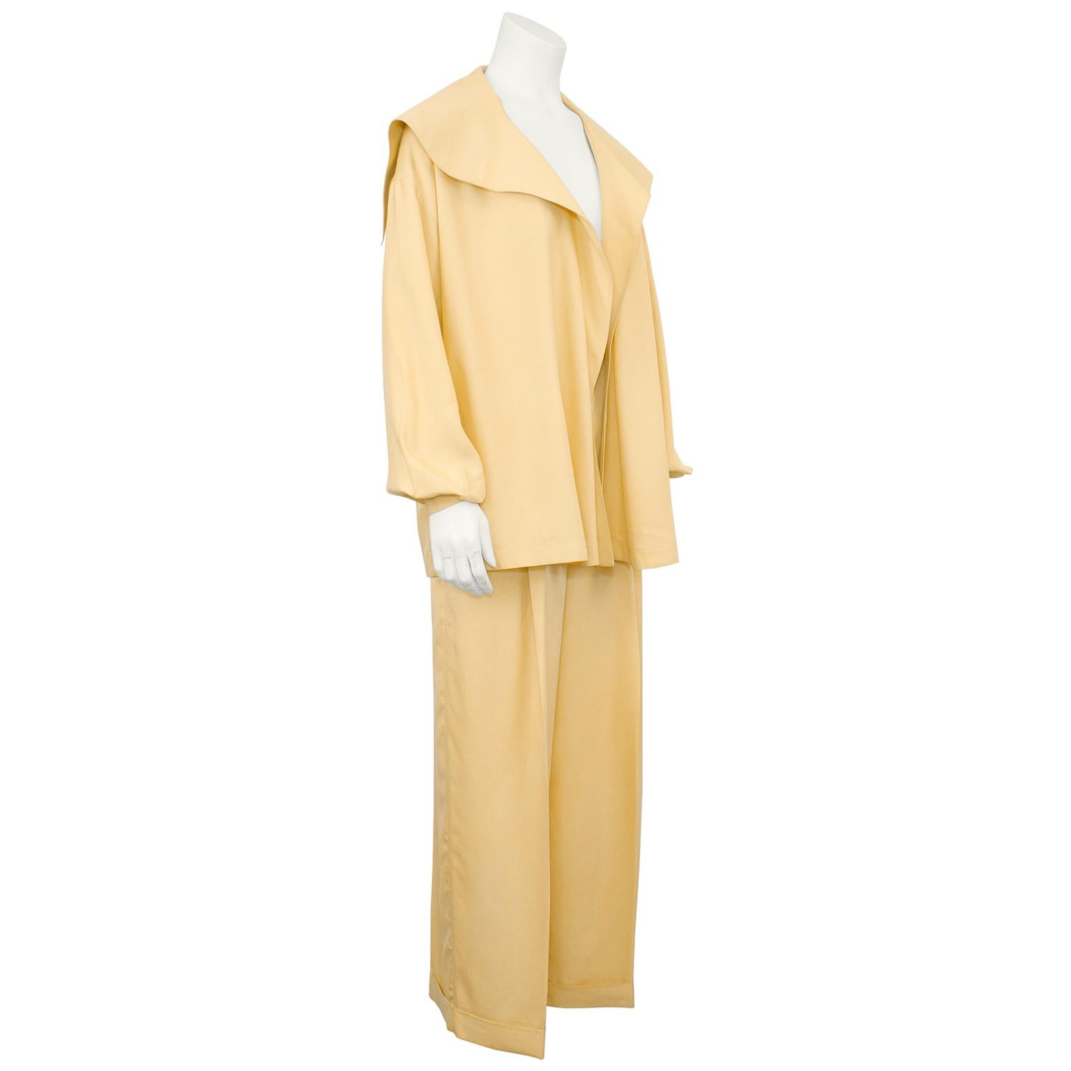Amazing Claude Montana lightweight silk jacket and trouser ensemble from the 1980s. The jacket is open and loose through the body with an oversized collar that comes to a sharp point and hangs over the shoulders. Bishop sleeves. Pants are