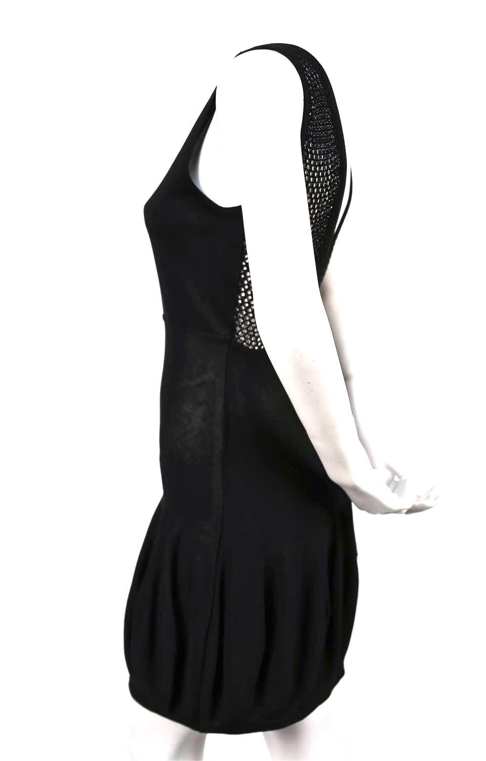 Very rare, uniquely shaped, jet-black knit dress with bubble hem and open knit back from Claude Montana dating to the 1980's. French size 40, which fits a US 4-6. Unstretched dress measures approximately 32