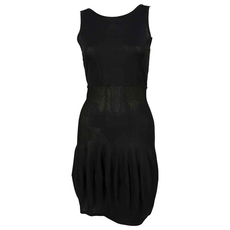 Very rare, uniquely shaped, jet-black knit dress with bubble hem and fishnet knit back from Claude Montana dating to the 1980's. French size 40, which fits a US 4-6. Unstretched dress measures approximately 32