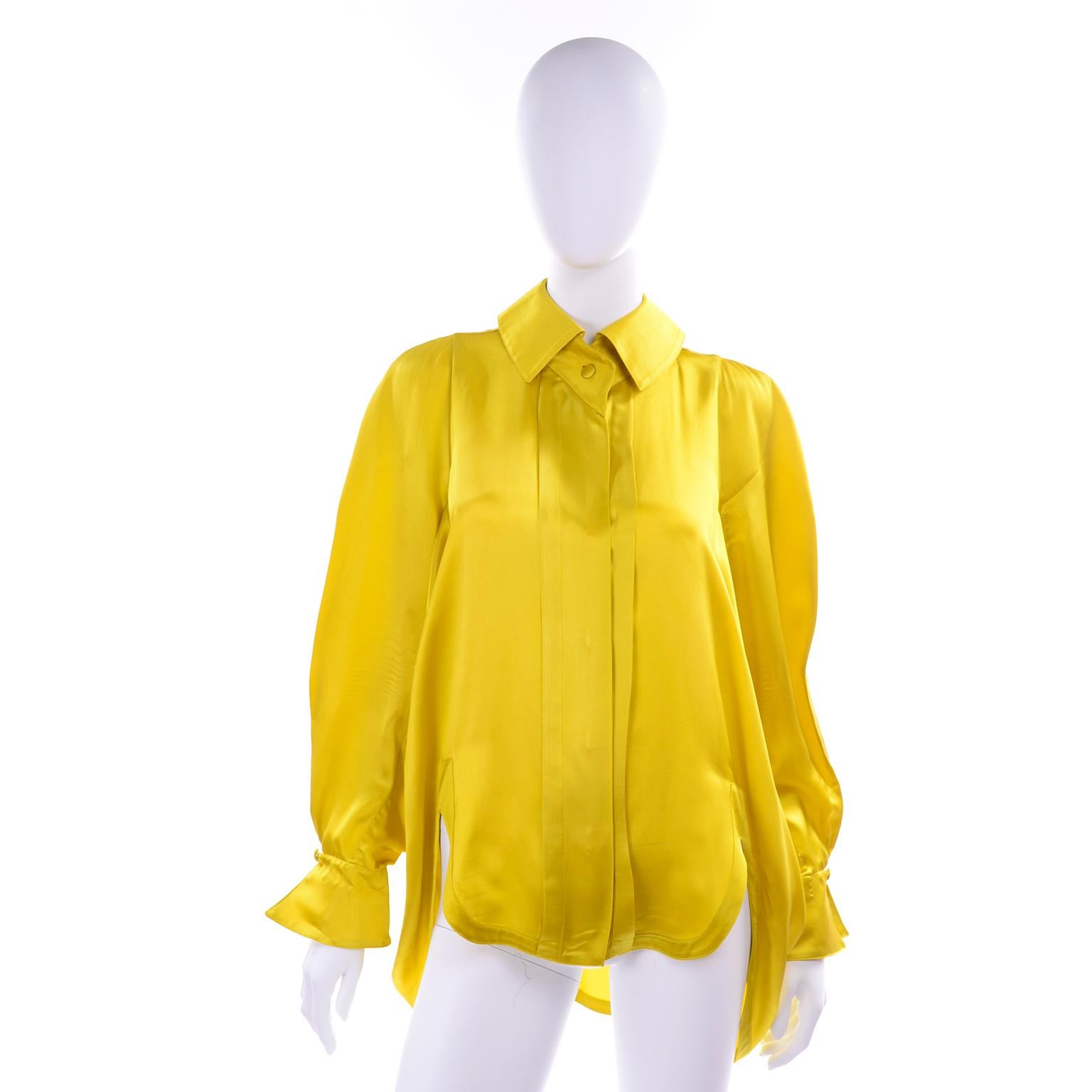 We love unique blouses and this blousy vintage chartreuse silk blouse from Claude Montana is sensational! The photos don't really show how amazing this top is. Long sleeves with pointed french style split cuffs with a decorative fabric covered