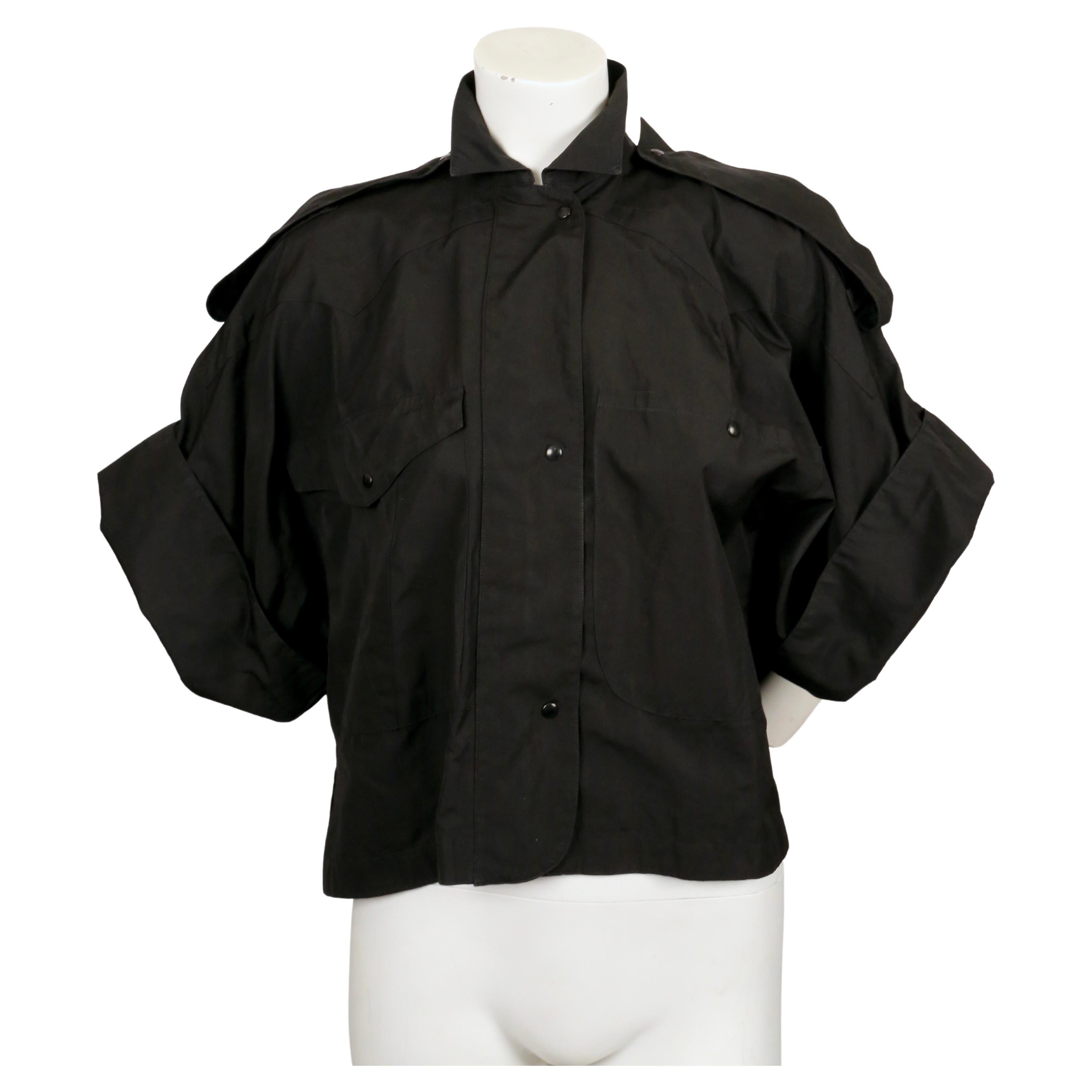 Cropped, black cotton, shirt jacket with short sleeves designed by Claude Montana dating to the late 1980's. French size 36 however this has a very oversized fit. Approximate measurements: drop shoulder 25.5