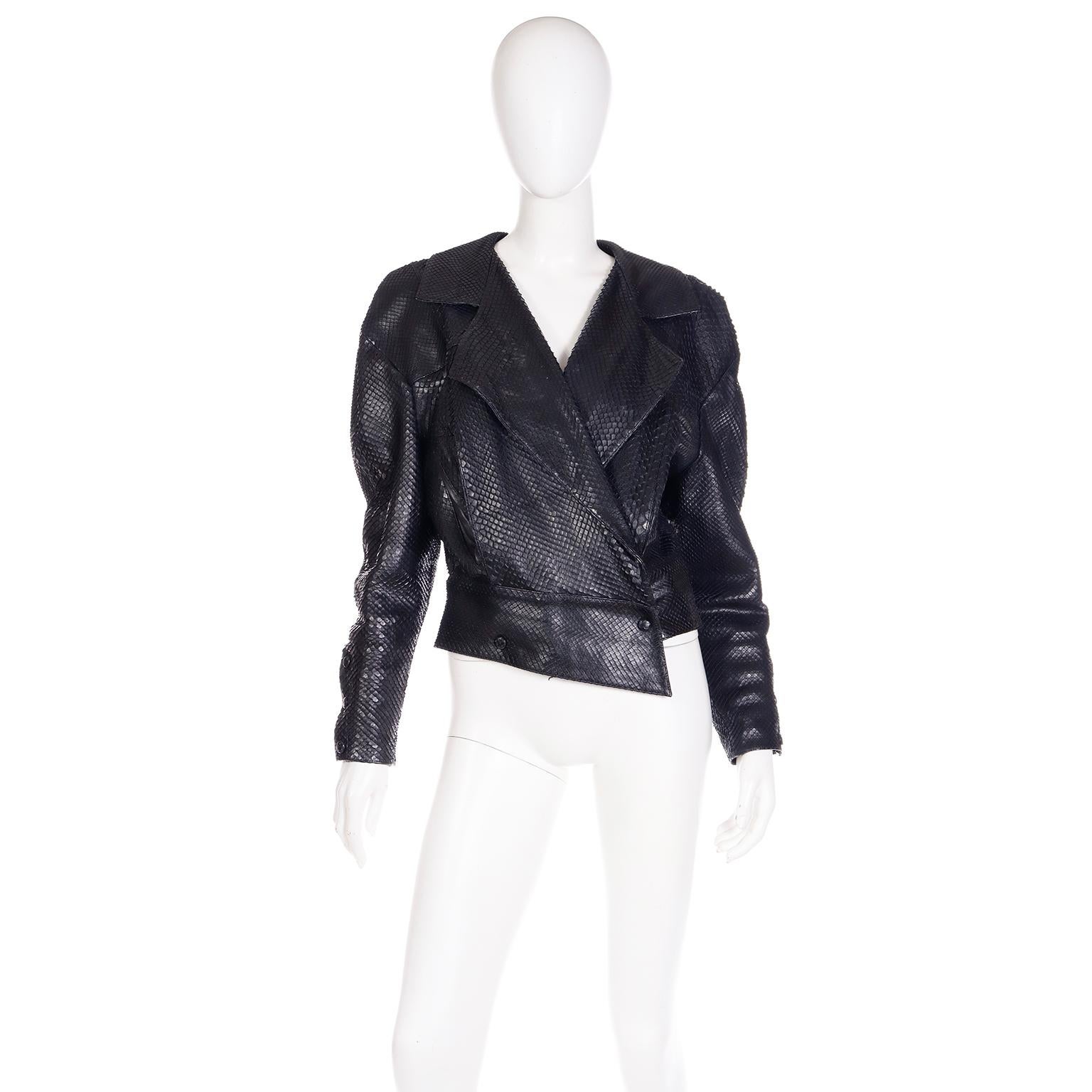 This vintage 1980's Claude Montana Pour Ideal Cuir jacket is a great example of Montana's technical proficiency with animal skins! This black luxurious anaconda snakeskin cropped jacket has a notch lapel, snap-front closure and slash pockets.  There