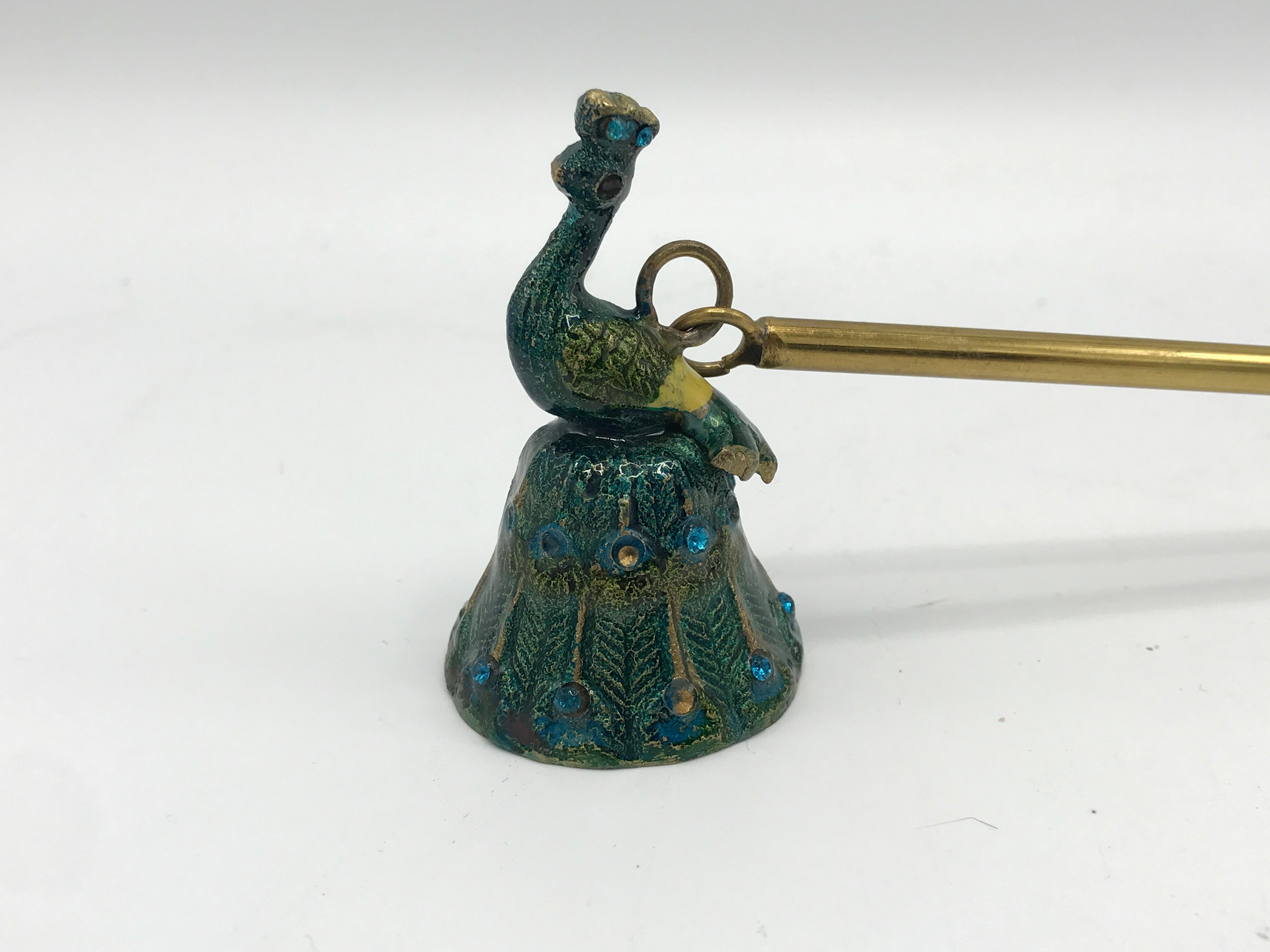Offered is a fabulous, 1980s cloisonne candle snuffer with a sculptural peacock motif. The Long handle is solid brass, connecting by loop and ring, to the cloisonne peacock. Handle measures 10in. Peacock measures: 2.25in height x 1.5in diameter.