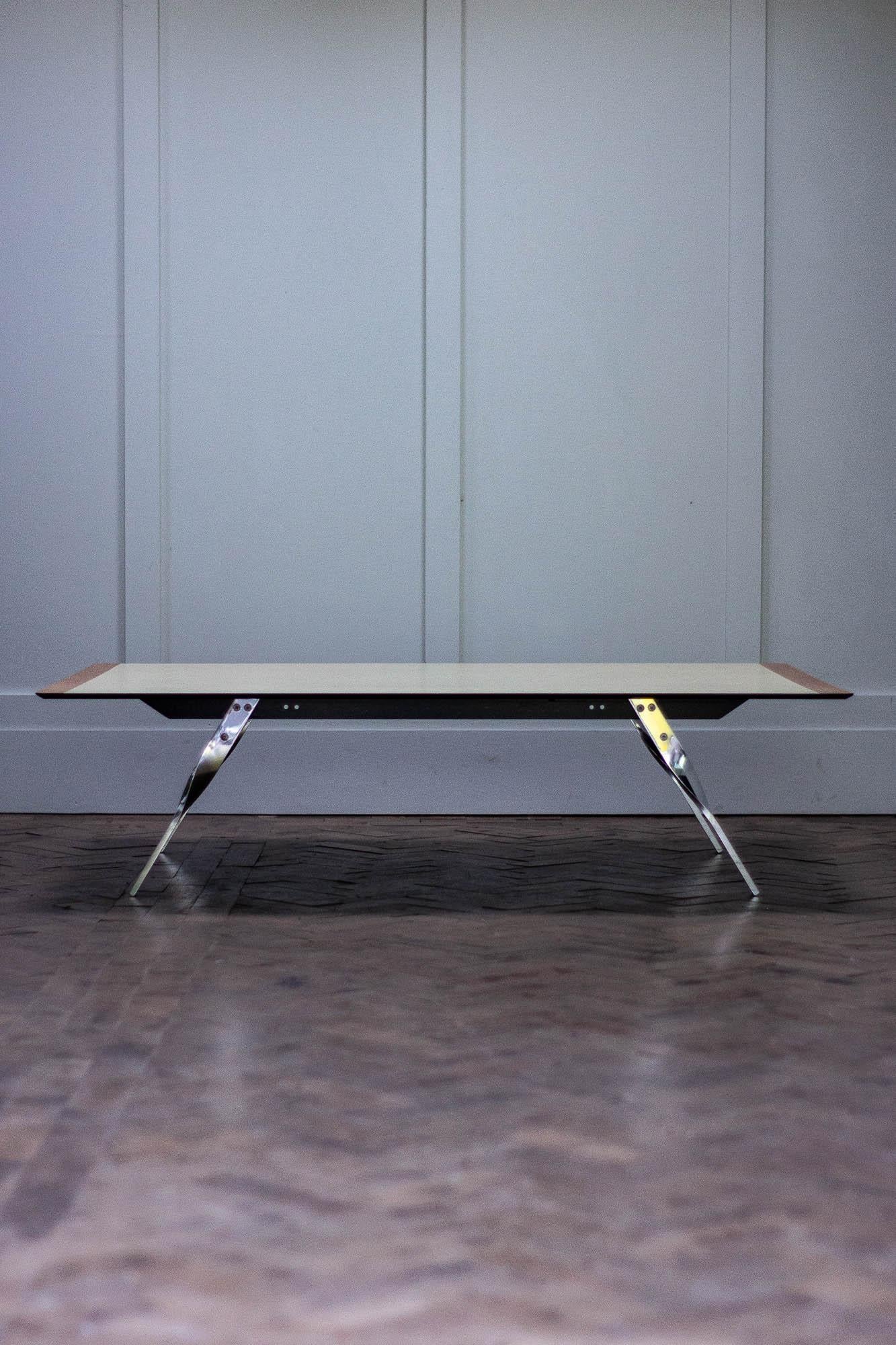 This 1980s coffee table has a aluminium frame with polished legs. 

The top is made of engineered plywood with a resin/formica finish, with timber strips at each end of the table top. 

Measures: Height 33cm
Length 128cm
Width 96cm.