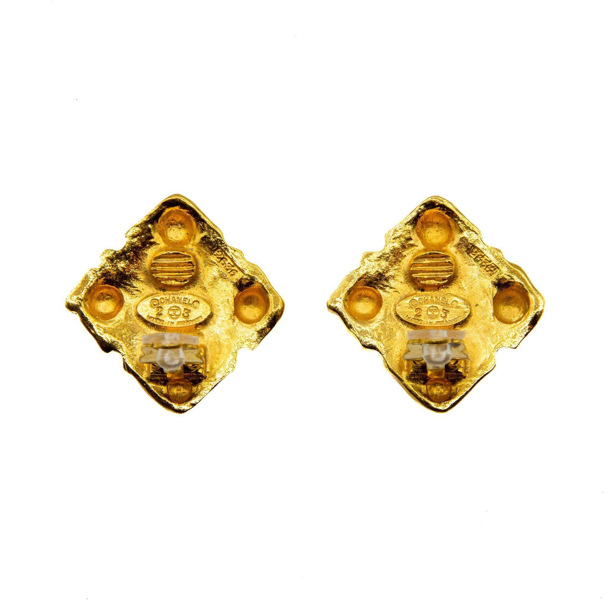 1980s Collection 23 Chanel Clip-on Earrings. In gold coloured gilt metal pressed with 12 circular domes wrapped around a faux pearl and 4 geometric patterned domes on each corner of the square shape. This piece carries the Chanel authenticity