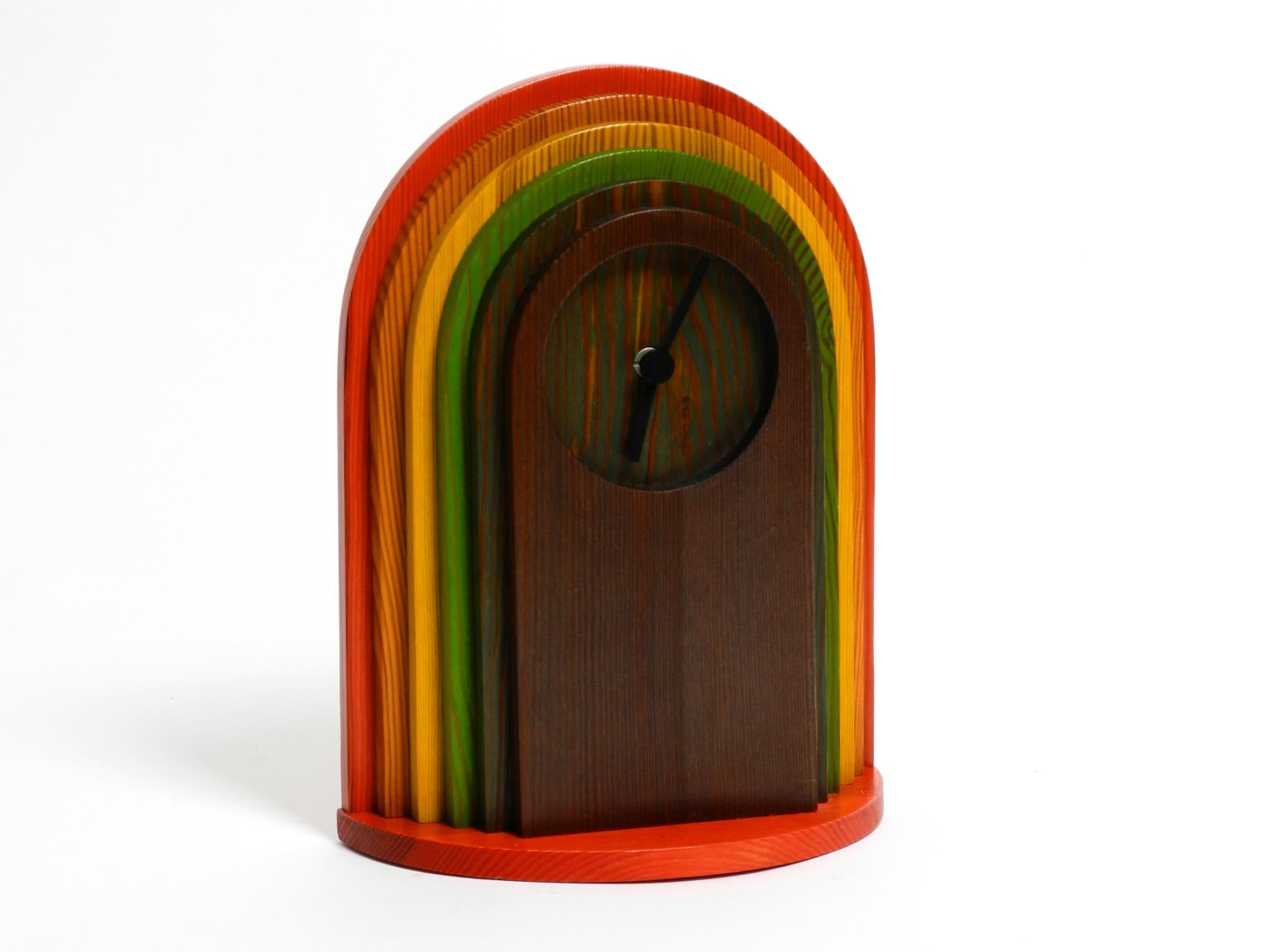 Beautiful 1980's colorful pine table clock.
Great minimalist postmodern design by Legnomagia. Made in Italy.
Made entirely by hand. With original label on the back.
Individual colorfully stained wooden elements are glued together.
With battery