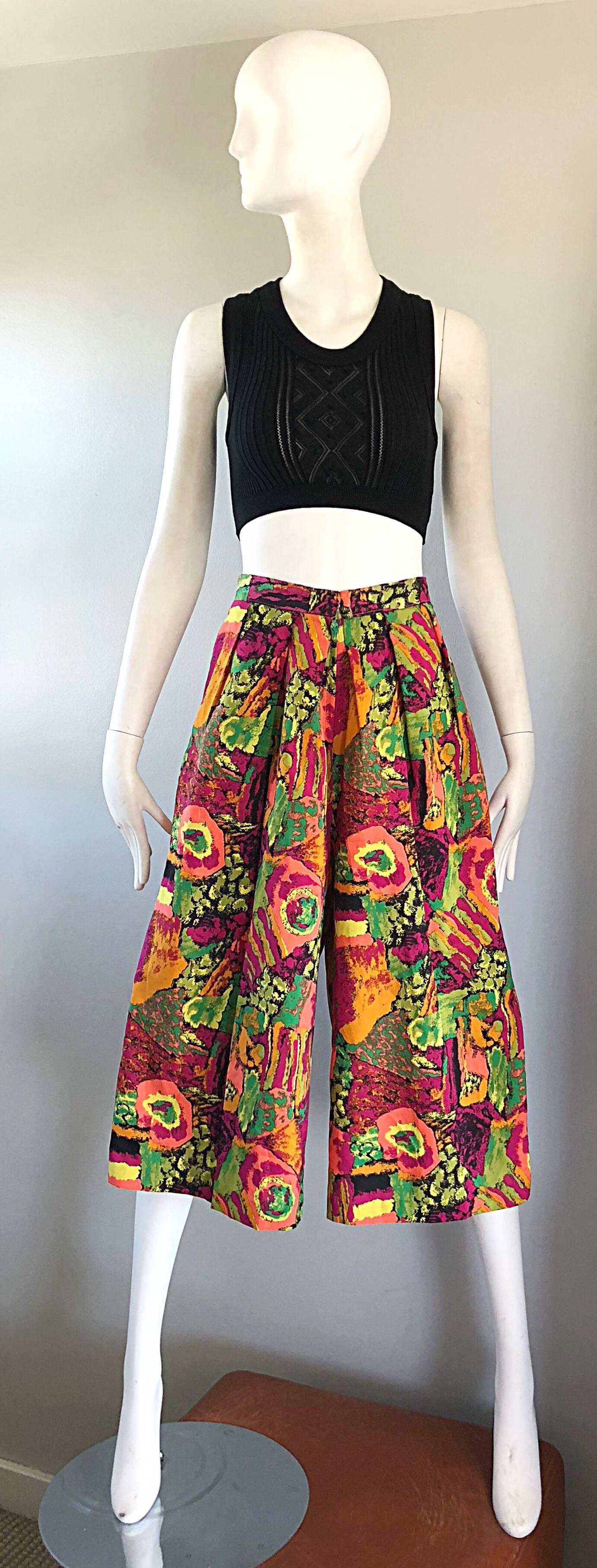 Fantastic 1980s colorful high waisted wide leg culottes shorts! Features abstract prints in fuchsia, pink, green, orange and yellow throughout. Button closure at fron center waist with a zipper fly. POCKETS at each side of the hip. The pictured 90s