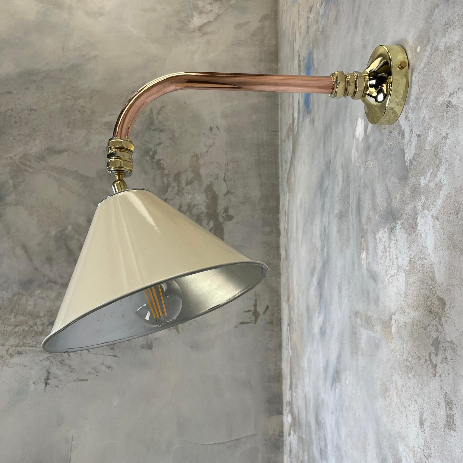 British army tilting festoon lamp shade fitted to a copper and brass cantilever wall fitting to create a bespoke wall light.

Professionally restored and converted by hand in UK by Loomlight to modern lighting standards, ready for contemporary