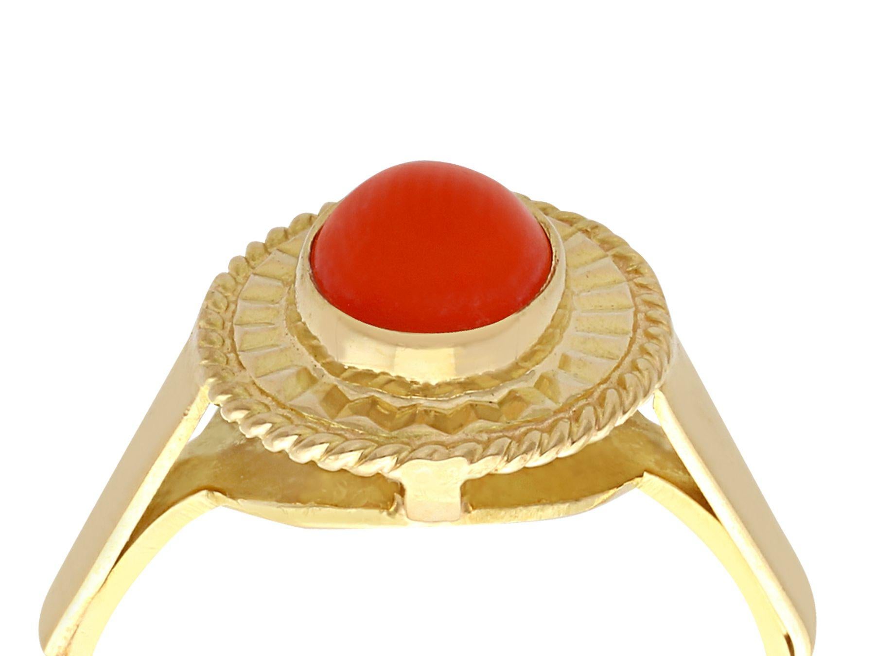 A fine and impressive coral and 18k yellow gold dress ring; part of our diverse vintage jewelry and estate jewelry collections.

This fine and impressive vintage cabochon cut coral dress ring has been crafted in 18k yellow gold.

The oval mount