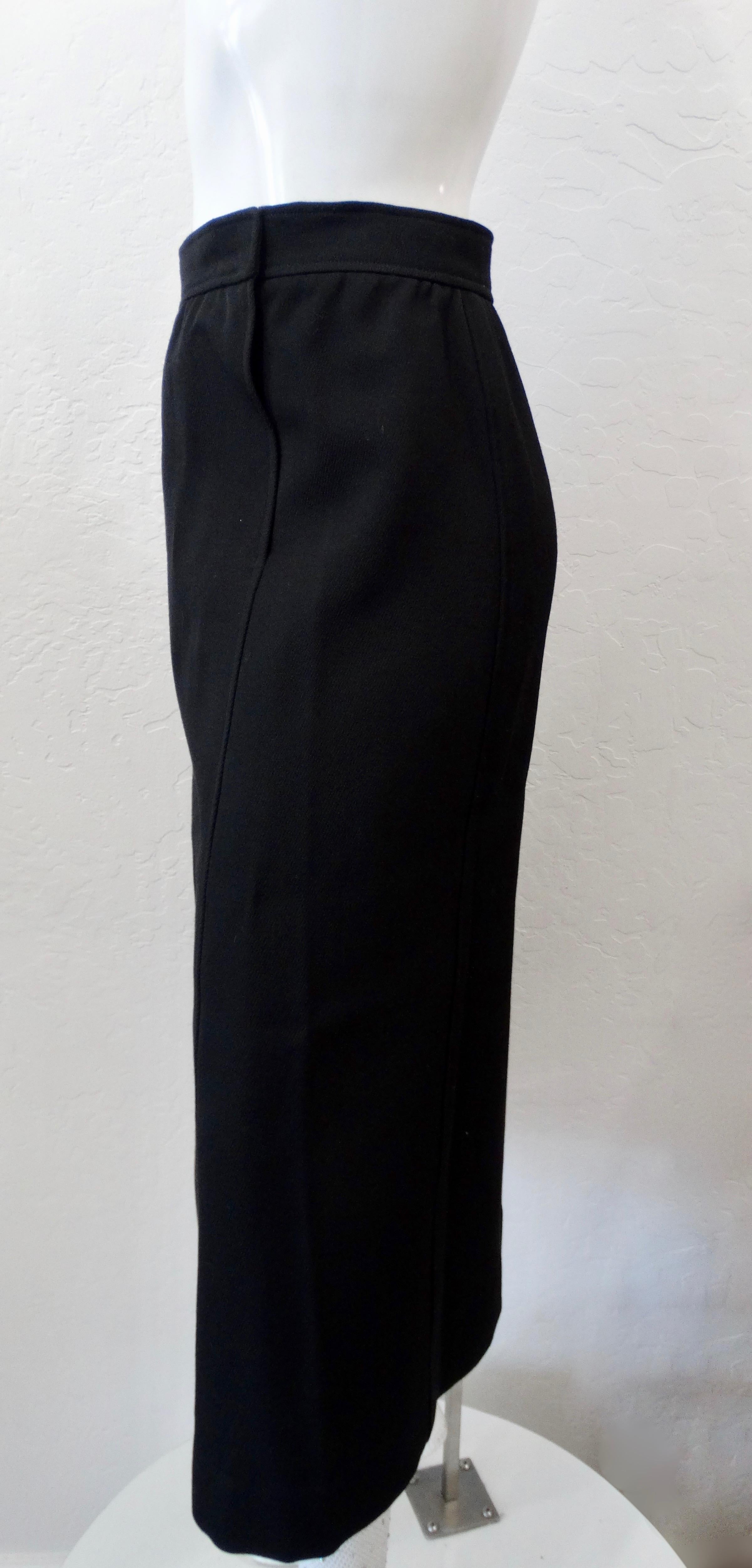 Snag yourself the most amazing and timeless skirt! Circa 1980s, this Courréges Paris skirt is made of black wool and features a flowy straight silhouette. Includes subtle pleating around the waist band and side slit pockets. Simple and chic, pair