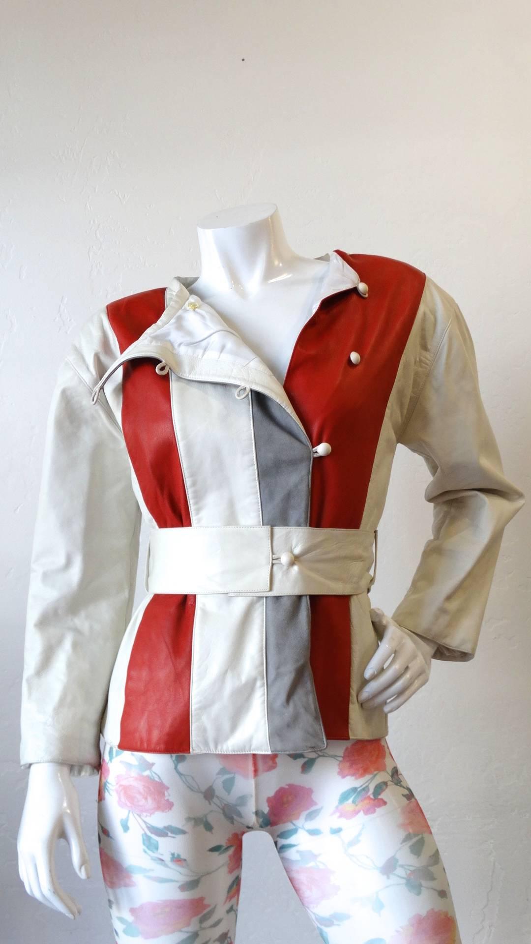 The most amazing mod inspired 1980s Courreges striped leather jacket! Made of a soft cream leather, accented with grey and red vertical stripes. Buttons up the side of the chest with white circular leather buttons. Waist cinches in perfectly with