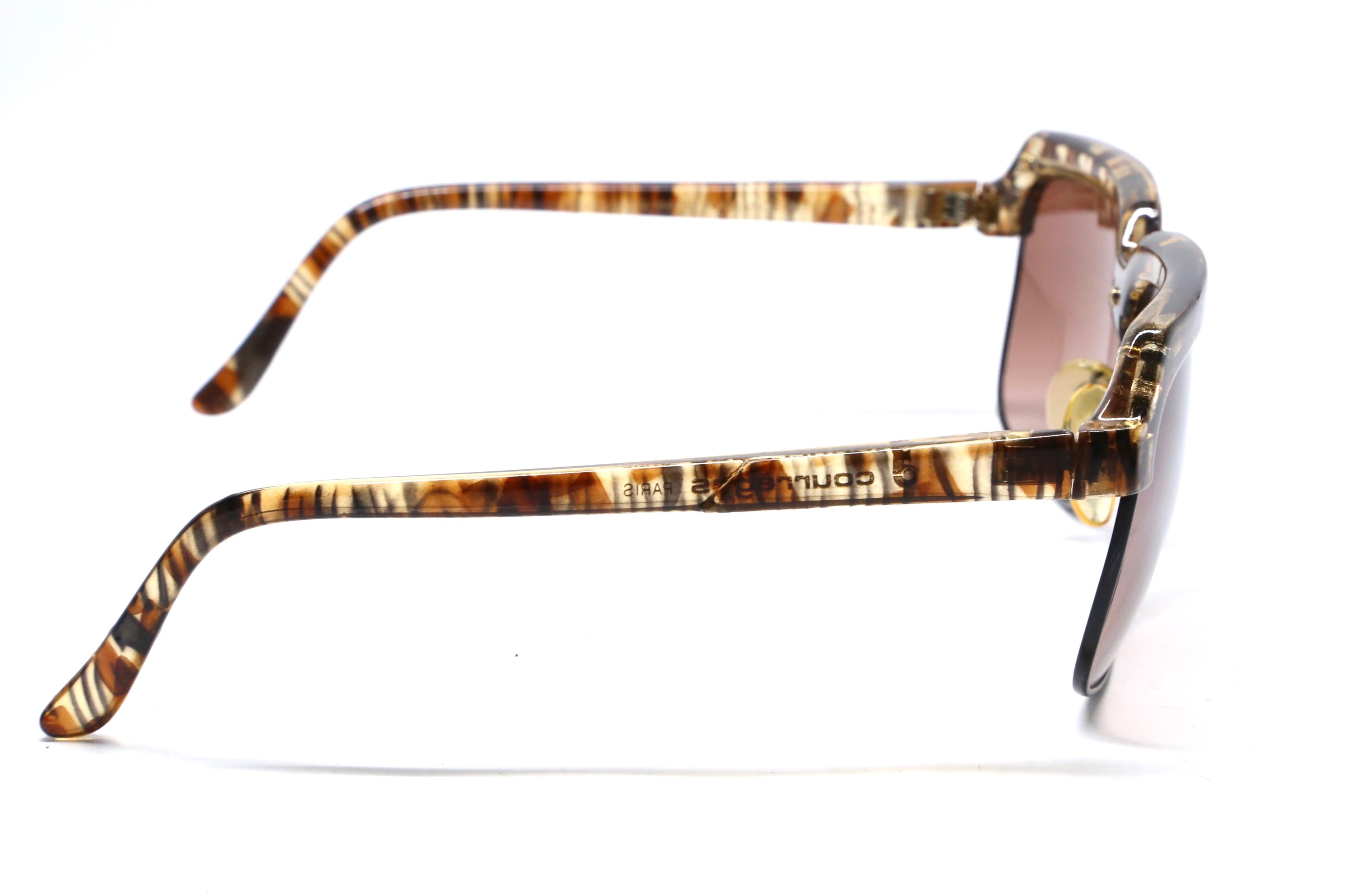 Uniquely shaped 'tortoise' style pattern frame sunglasses with rose-brown hued lenses from Courreges dating to the 1980's. Frames measure approximately:  just over 5.75