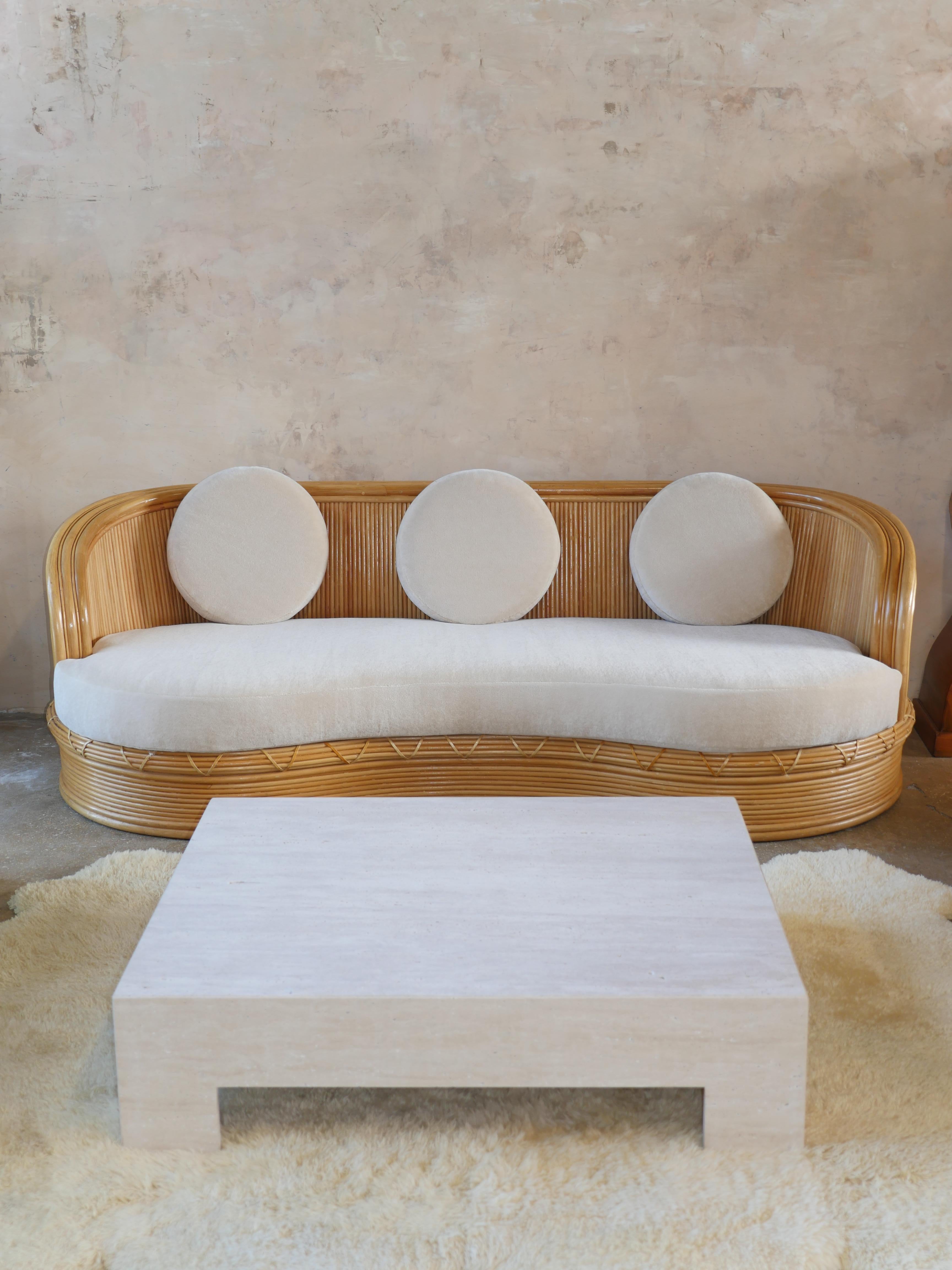 Vintage 1980s stacked pencil reed rattan sofa with leather detailing and beautiful Pierre Frey teddy mohair upholstery. This sculptural rattan sofa will add a nice touch of elegance and warmth, to any space. The fabric has been modernized in a