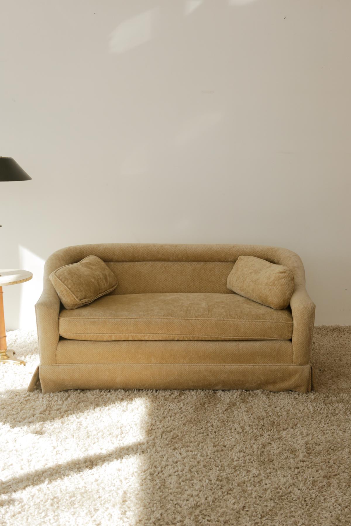 Where there’s a living room, there’s a sofa and many memories to be made.

This retro 80’s custom made love sofa is upholstered in a durable velvet tan fabric. Elegantly curved back and arms. Super comfortable with plush cushions. One of a kind.