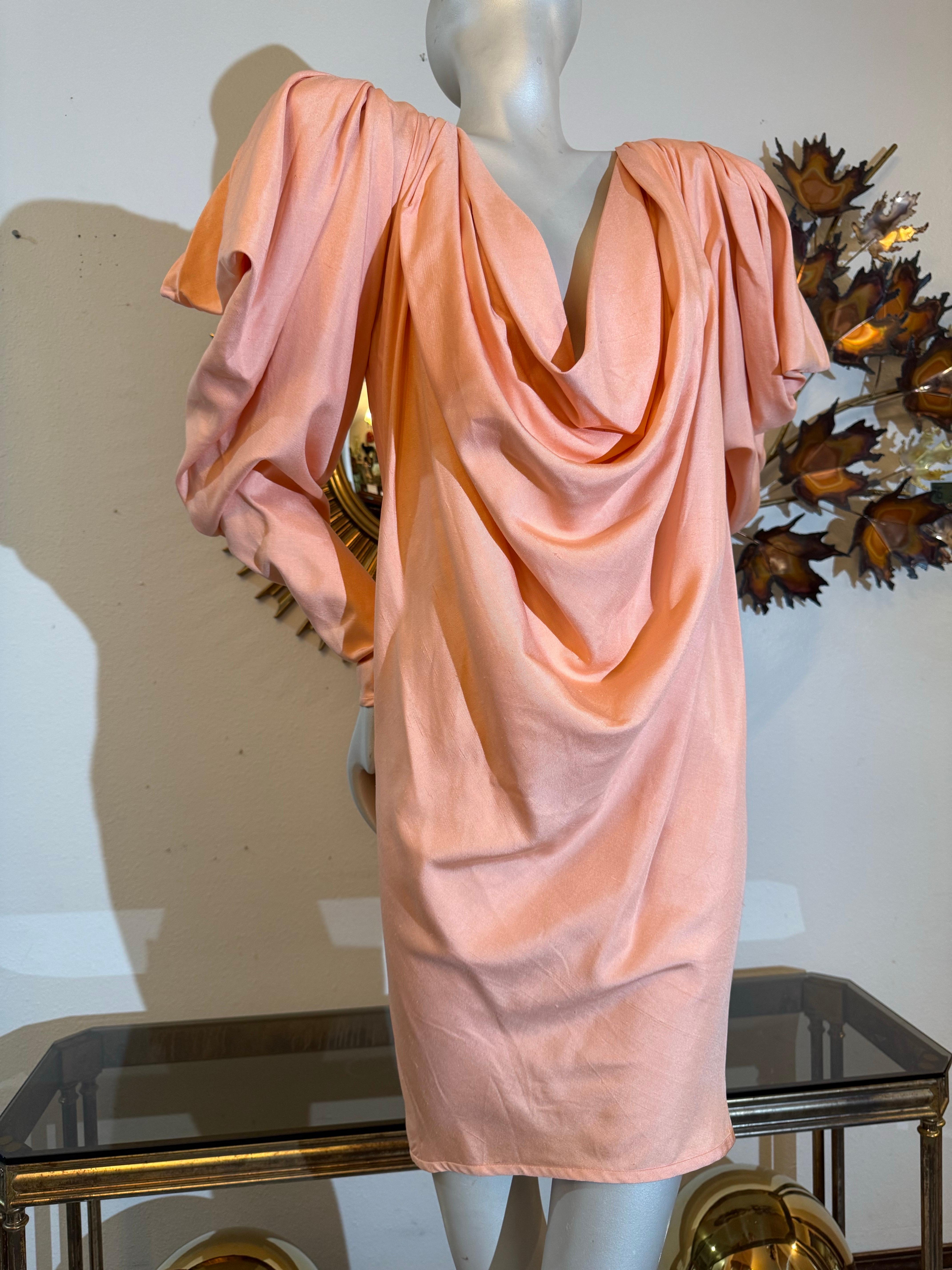 1980s Custom-Made Spring/Summer Peach Silk Drape Mini w Extreme Shoulders:  A lovely textured silk in a spring/summer weight with Avant Garde structured, padded and draped shoulder silhouette. Simple chemise-style body. Very low-cut cowl neckline.