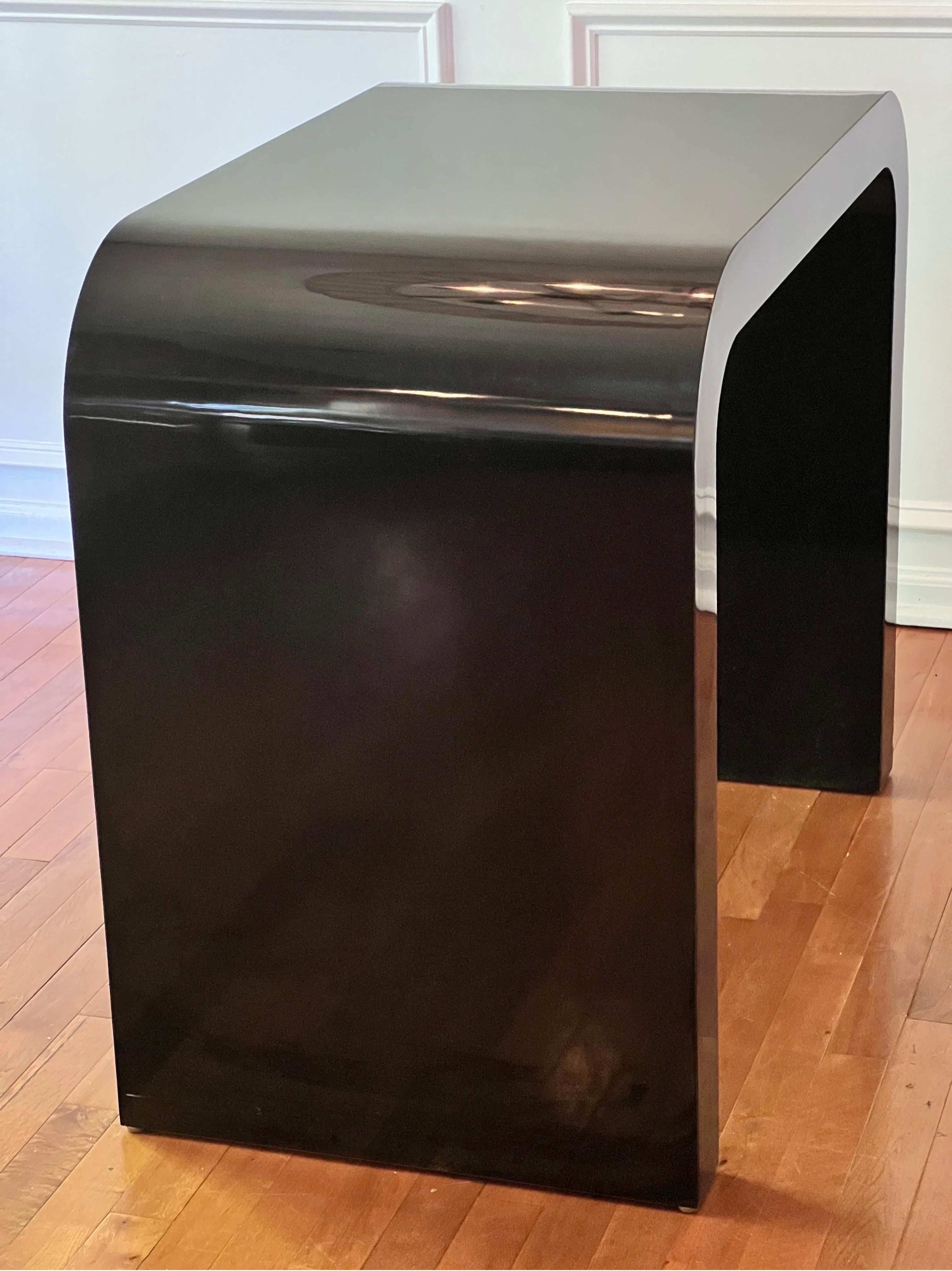Stunning post-modern custom jet black lacquered waterfall console table. 

Boasting a sleek and seamless design, this table is three inches thick all around. The glossy jet black is fabulous and makes a statement while the table size offers great