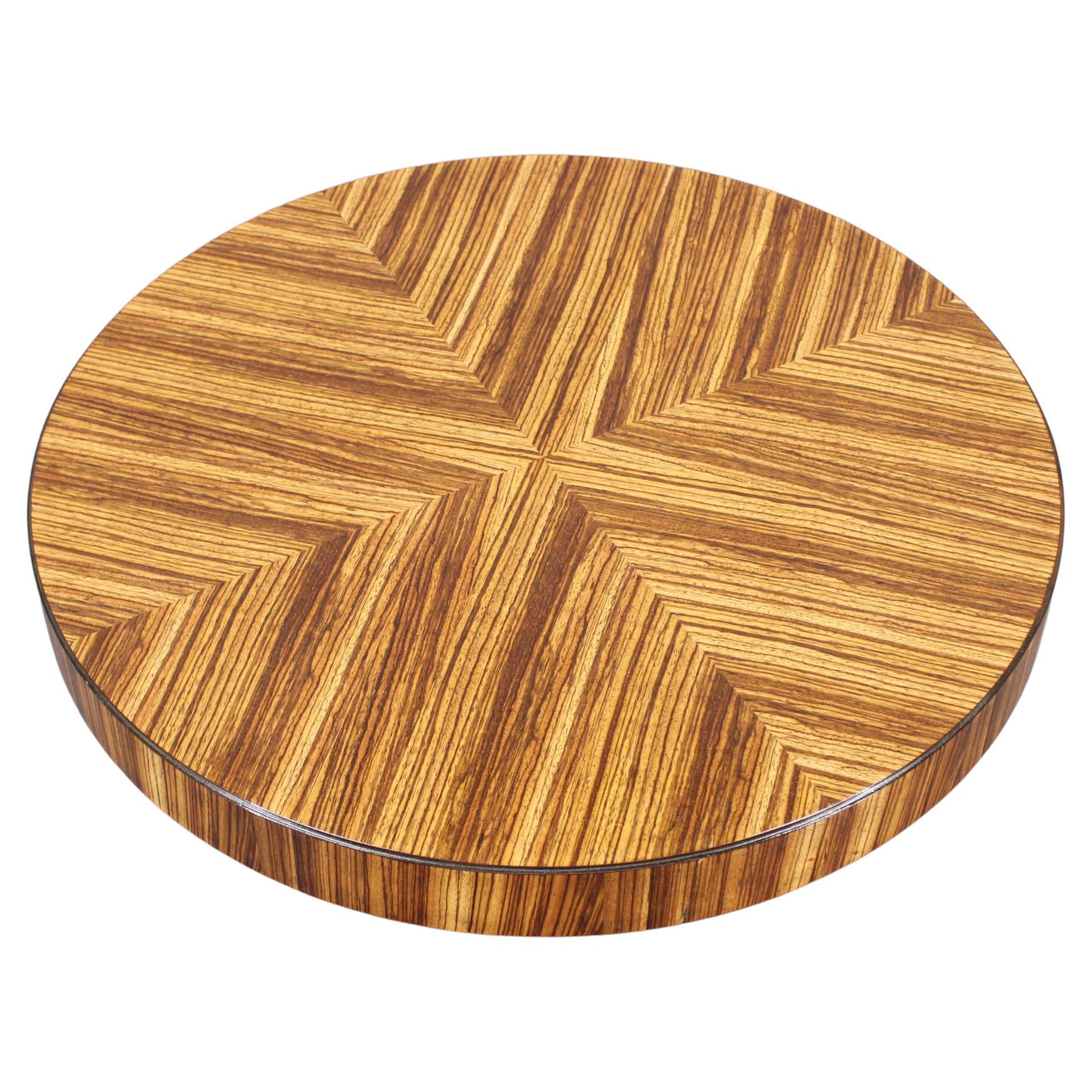 Cubist style side table made in Czechoslovakia in the 1980s, featuring a striking round top with patterned veneer and a sculptural solid wood base. The column is lacquered in black, while the tabletop is treated with oil for a rich, tactile finish.