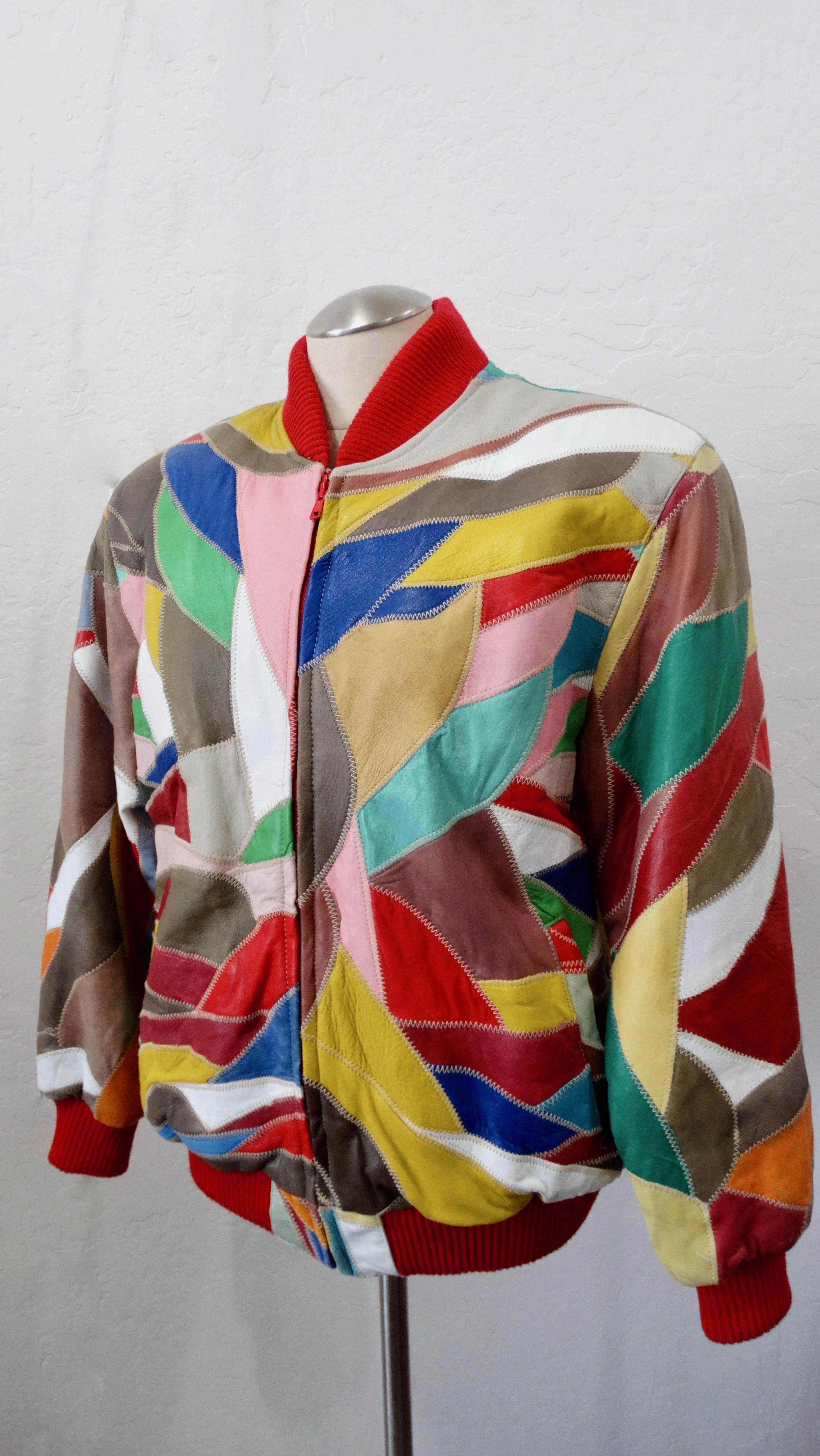 Stay in style while beating the cold weather! Circa 1980s, this plush oversized bomber jacket by David Green features appliqué patchwork in multi-colored leather and exposed stitching. The collar, cuffs and bottom hem are trimmed with vibrant red