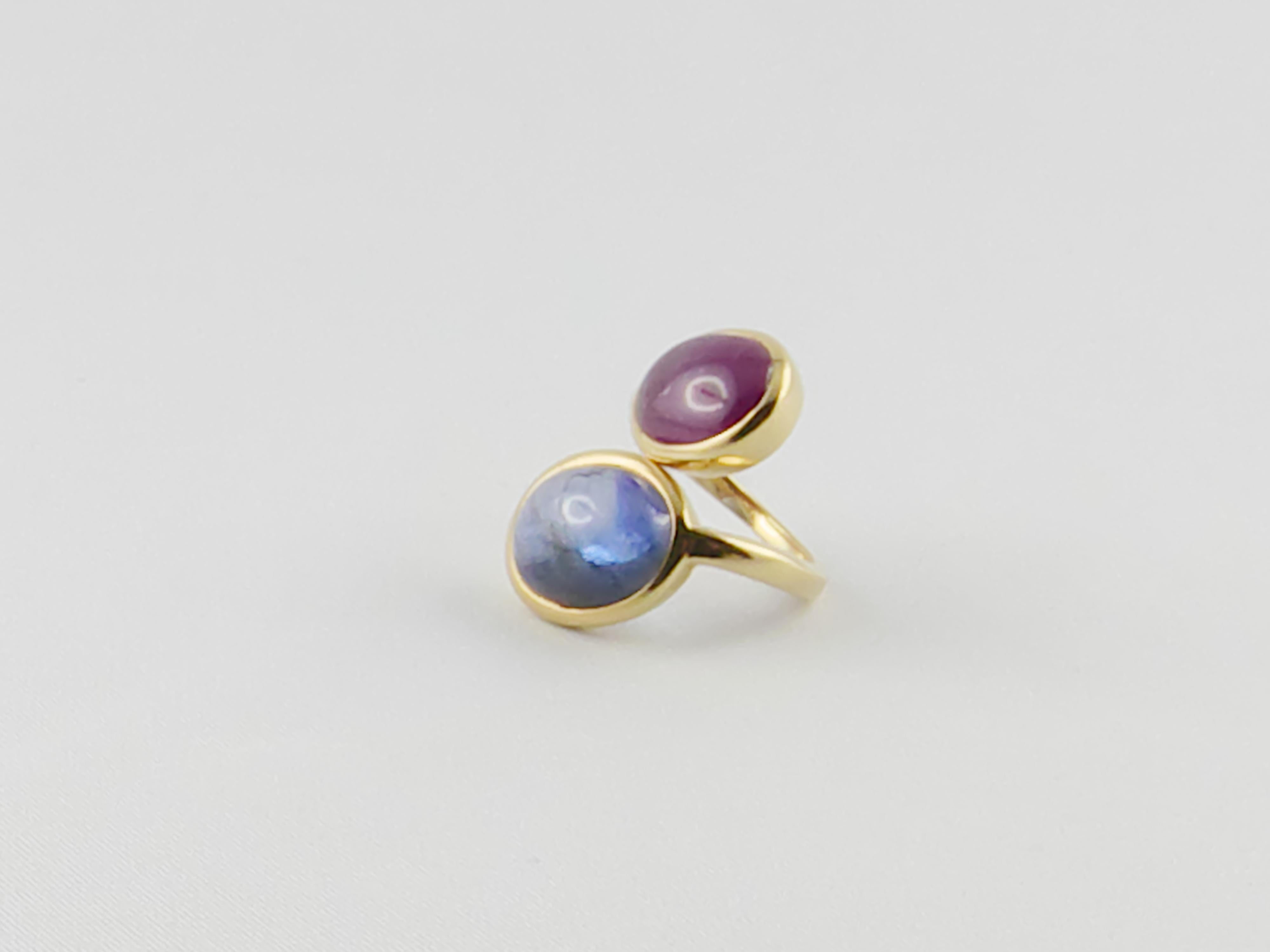 Old David Webb Ruby and Sapphire Cabochon  18 karat Gold  Ring
The two gorgeous gems, set in a tapering crossover shank, mounted in 18ct Yellow Gold give an extremely elegant, glamourous and sophisticated look.
This delightful  Crossover Ring can be