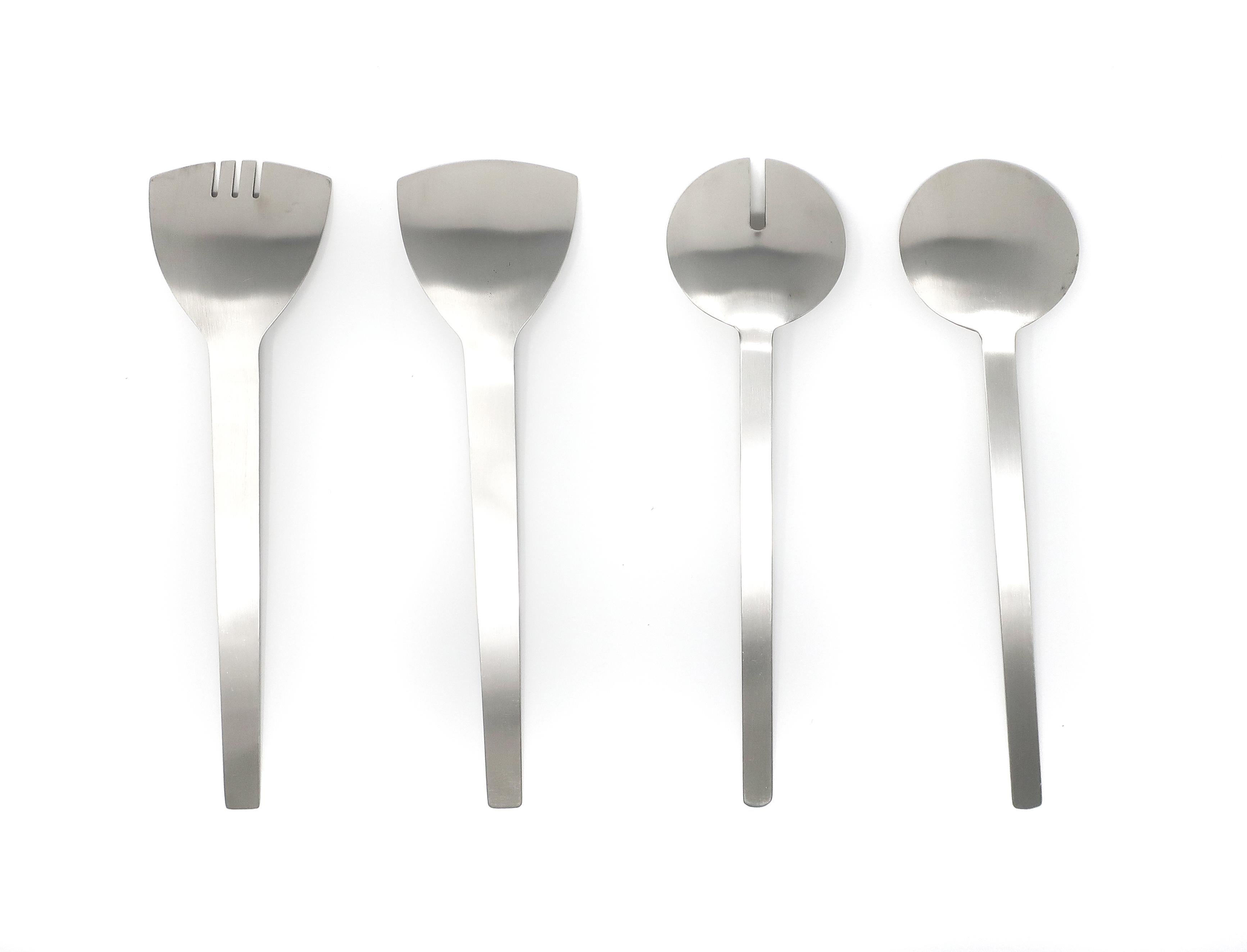 A handsome set of four 1980s Art Deco-inspired serving utensils. All have thin and elegant stainless steel handles, two with round heads and two have triangular heads. In excellent vintage condition with no signs of use. No maker’s
