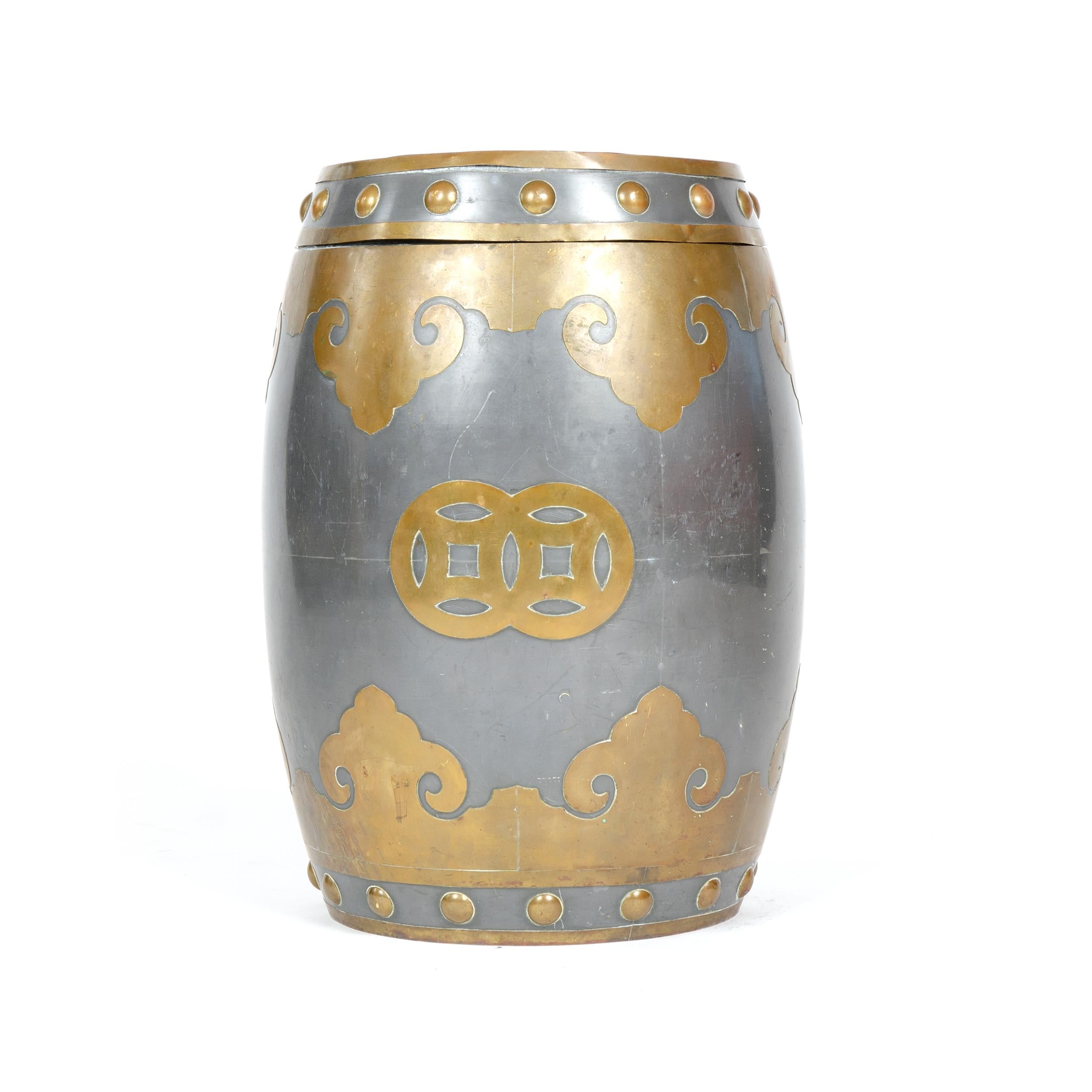 An ovoid, barrel shaped covered metal container, umbrella stand, or end table with decorative brass overlays.