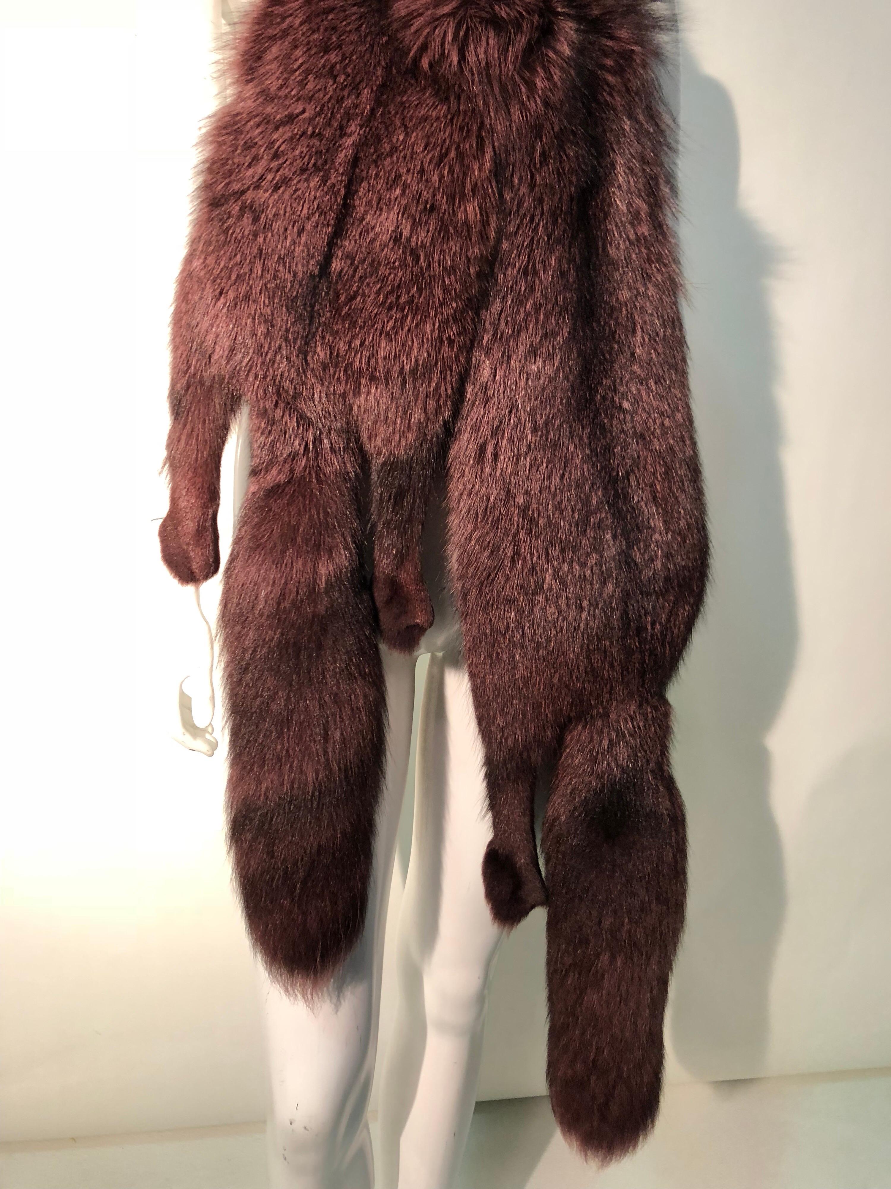 A fabulously luxurious 1980s double-pelt fox stole, over-dyed in mauve with one head that clasps at jaw, tails, eyes and paws (no claws). Quite dramatic and glamorous! 