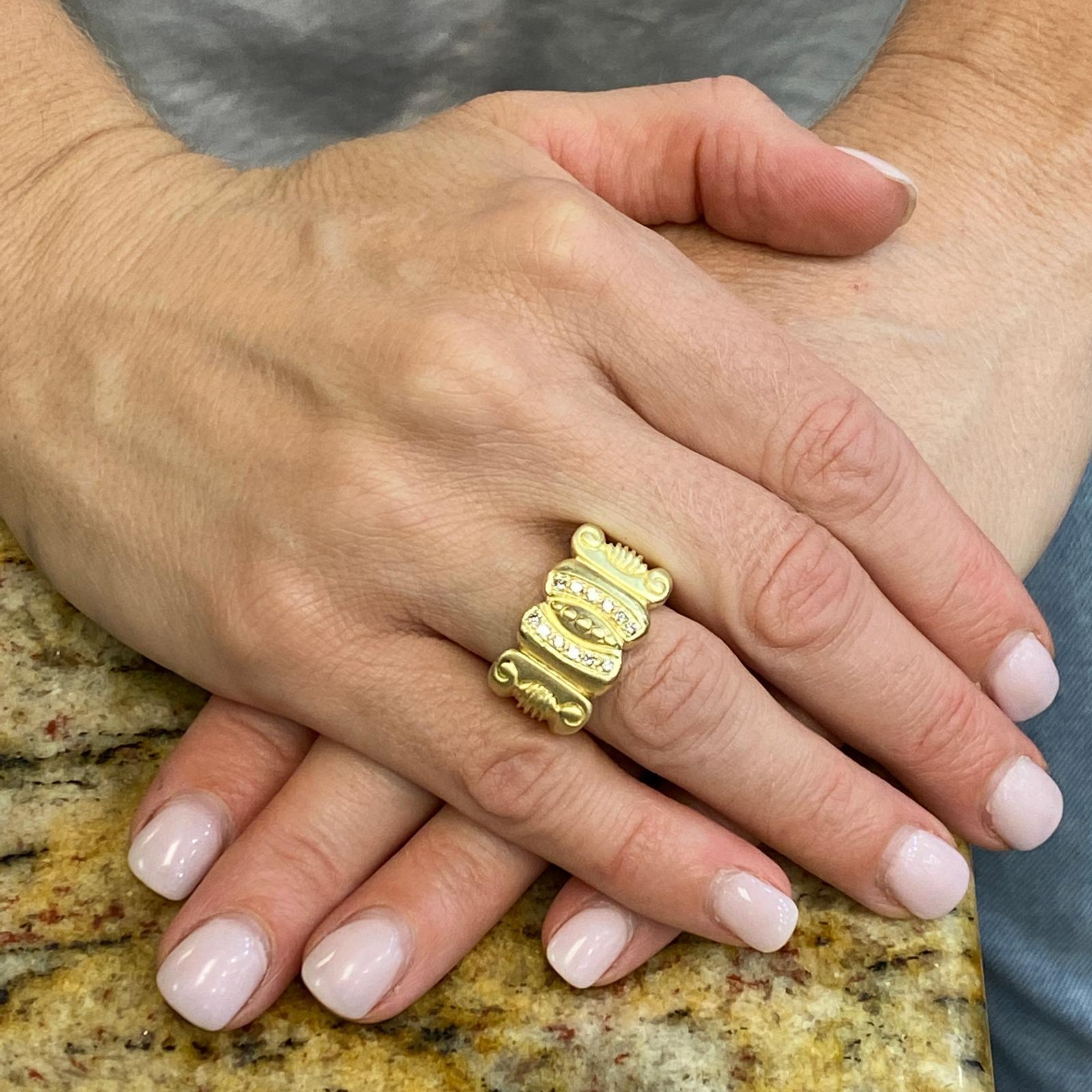 Beautiful diamond satin finish 18 karat yellow gold ring by designer Vahe Naltchayan. The ring, circa 1987, features 12 round brilliant cut diamond accents weighing .12 carat total weight and graded F-G color and VS clarity. The ring has an etruscan