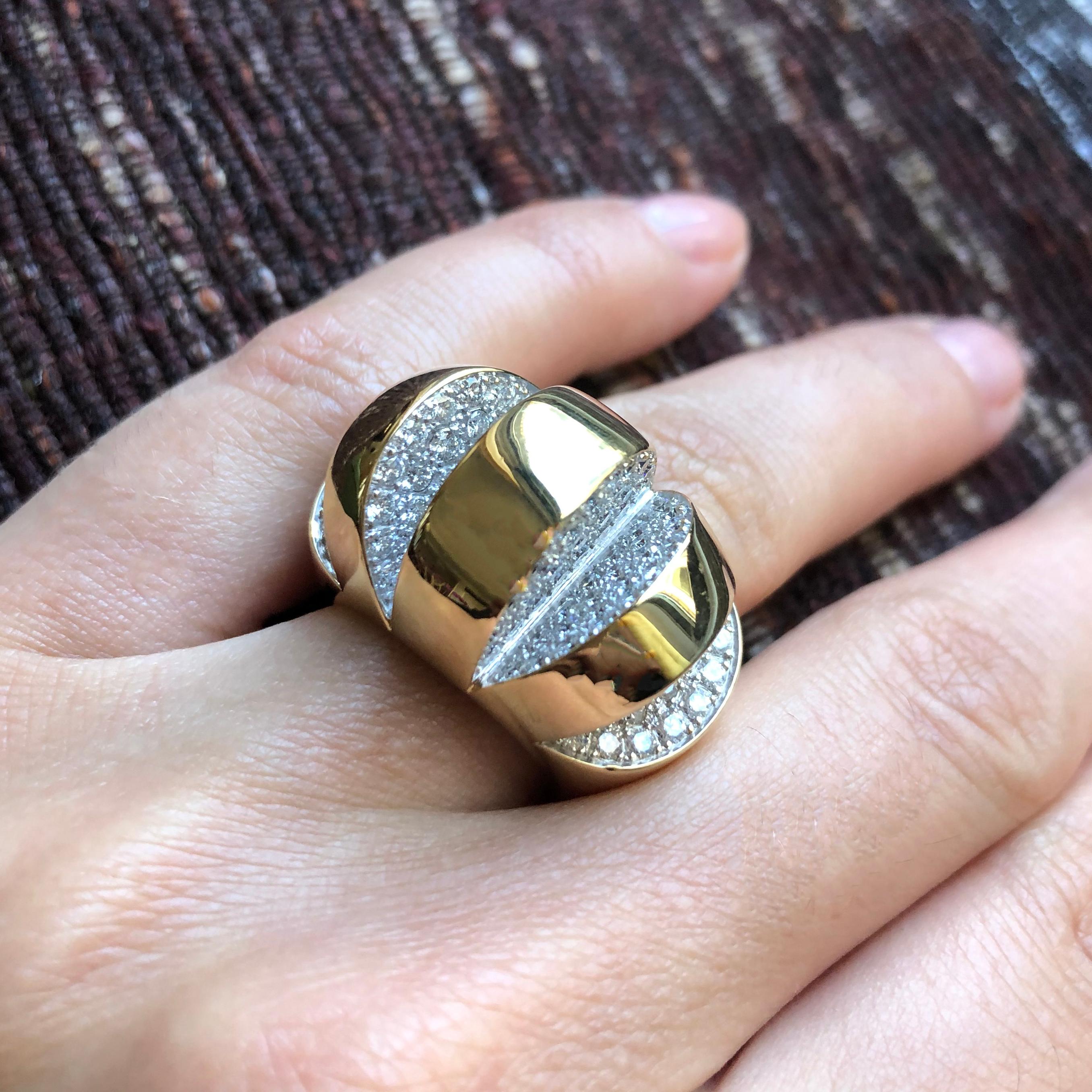 A true showstopper and beautifully crafted, this is the cocktail ring to own. It is a diamond pave and 18 karat gold cut-out ring, c. 1980, a rich gold circle which has been opened up to reveal several parts. The ring has approximately 4 carats of