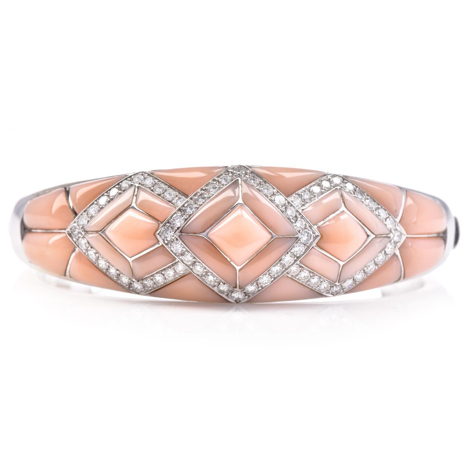 Introducing an alluring estate jewelry piece: a bangle bracelet featuring an elegant blend of coral and diamonds made in 18K White gold. The bracelet showcases a captivating pink coral inlay meticulously adorned with pave-set natural diamonds, all