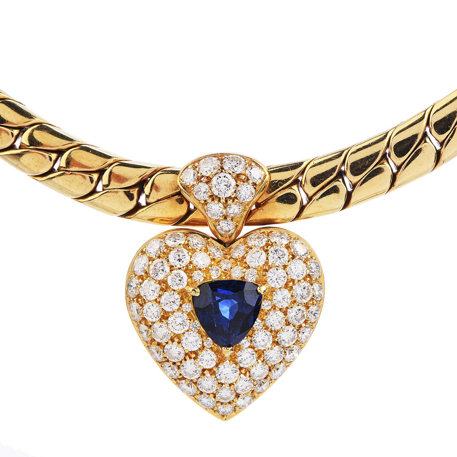 This vintage Diamond & Blue Sapphire Heart Inspired Pendant with a cerb Link Chain Necklace,

It is crafted in solid 18K Yellow Gold and weighs 68.5 grams. This 1980's Piece showcases a smooth set of 76 round-cut diamonds weighing approx.