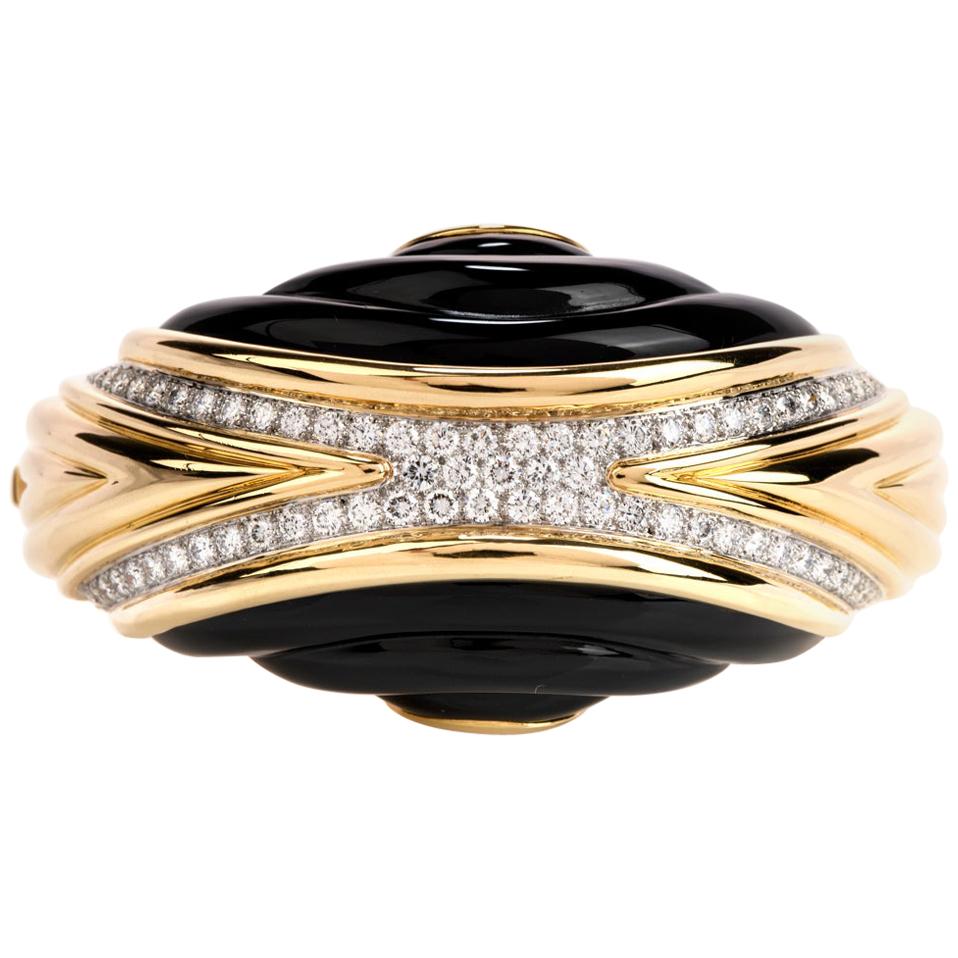 Treat yourself with this trending Chic early 1980s Diamond and onyx large bangle bracelet. It is crafted in 18K yellow gold, topped with extra white natural diamonds, and a pave set.

Material: 18K yellow gold

Width: 40mm ( 1.50 inches)

Wrist