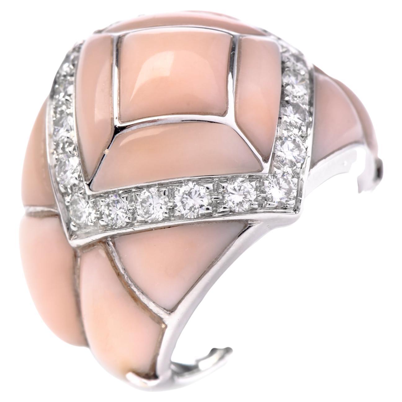 This 1980s jewelry cocktail ring features an elegant blend of coral and diamonds made in 18K White gold. The Estate coral ring showcases a captivating pink coral inlay meticulously adorned with pave-set natural diamonds, all expertly set in solid