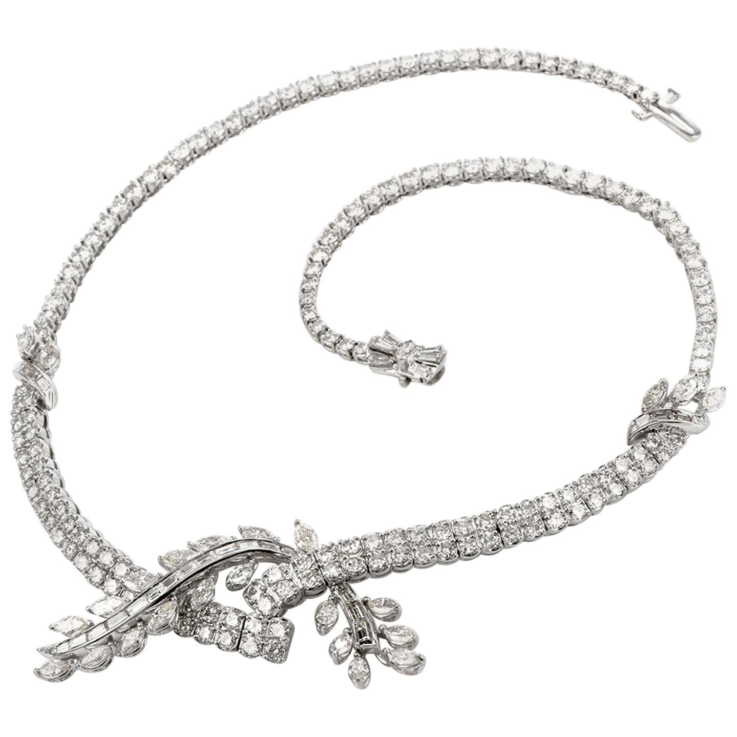 This exquisite Diamond necklace was inspired in a Riviera Bypass Floral motif and 

crafted in Platinum. The bypass floral design is created with marquise, round and baguette cut

diamonds totalling a weight of approximately 23.28 ct and 

are of