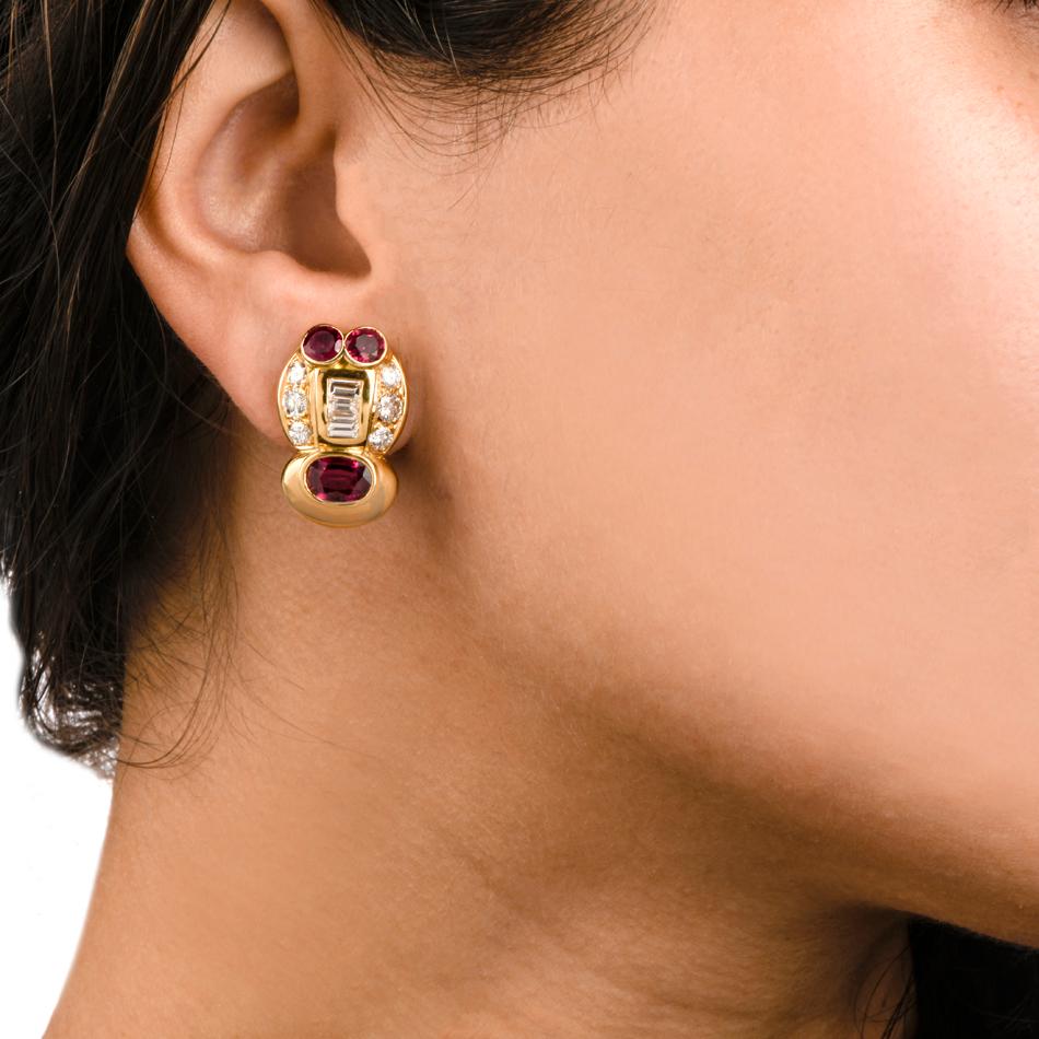 These stylish 1980's earrings are crafted in 18K yellow gold, featuring 6 GIA lab reported genuine vibrant rubies weighing approx. 4.75 carats in total. They are set with very high grade round and 6 baguettes diamonds weighing approx 2.20 carats
