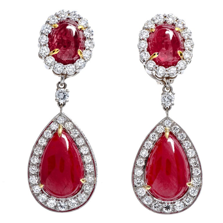 Dazzle yourself day or night with these Glamorous Red Ruby & Diamond Earrings.  

 Clip-on with foldable post crafted in luxurious Platinum.

Surrounded by a halo of (74) round-cut, prong set, genuine Diamonds weighing approximately 3.62 carats