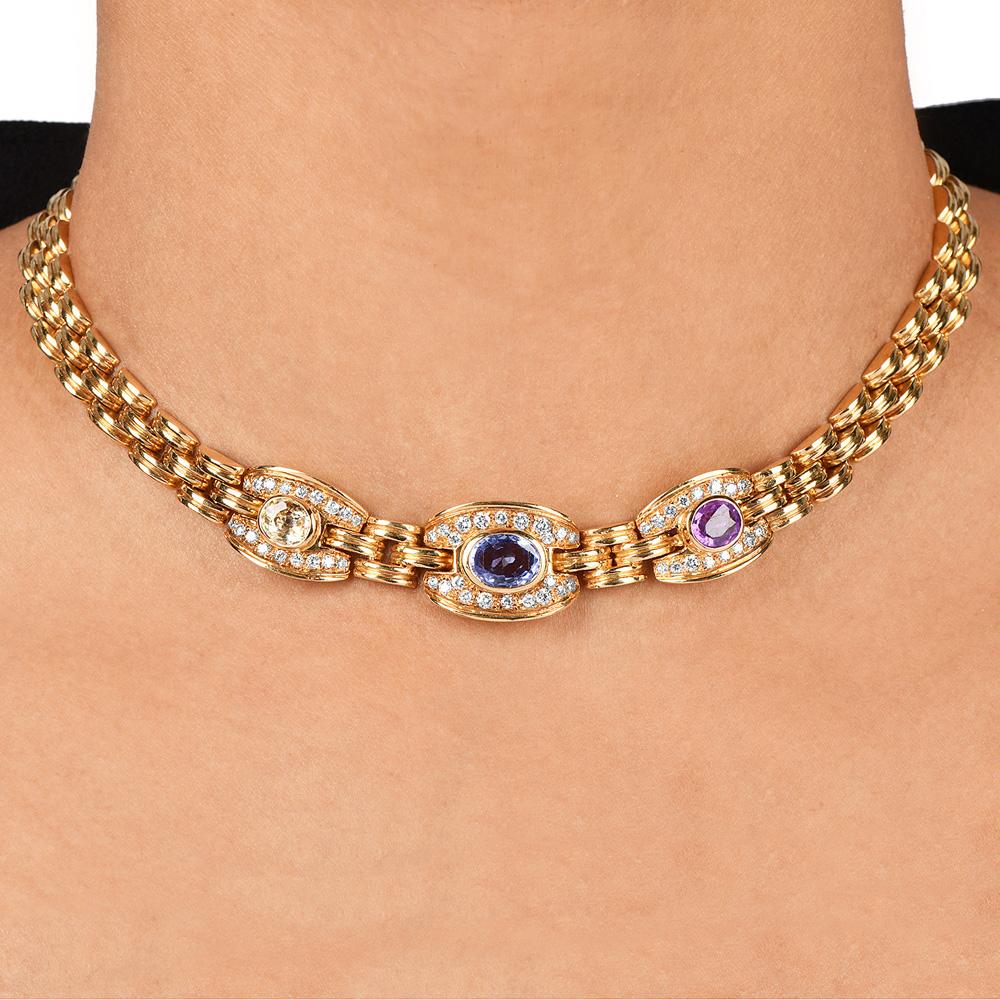 This lovely classic diamond, sapphire panther design gold necklace is gracefully crafted in 18k yellow gold.

Centered with three oval-shaped genuine blue, yellow, and purple sapphires and round-cut natural diamonds surround the colored gems,