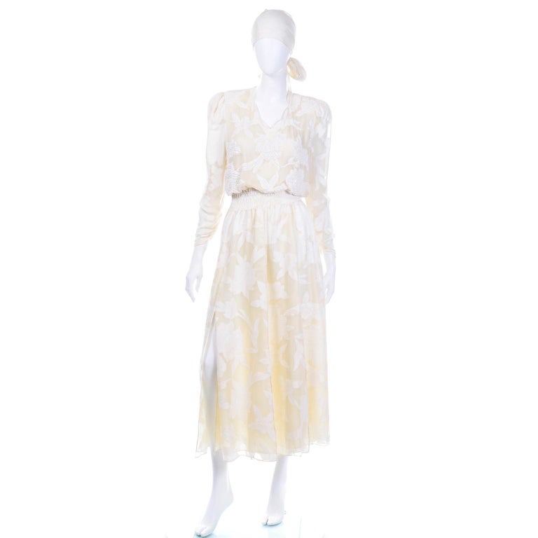 This is a stunning 1980's ivory 100% silk beaded floral long sleeve dress designed by the amazing Diane Freis. We have this same dress silhouette in many colors and patterns, but this is our only solid colored one. The tonal floral design on the