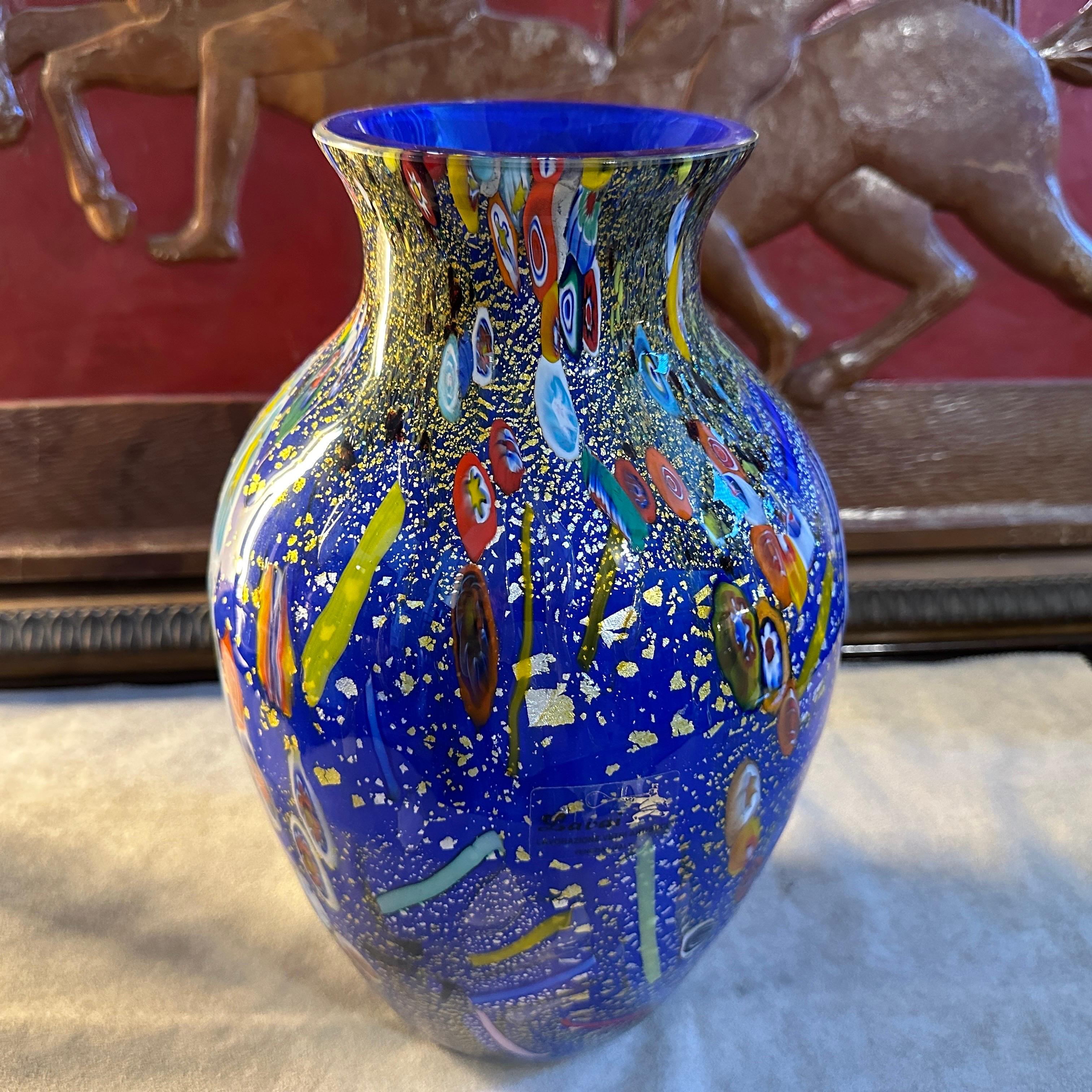 A particular blue Murano glass vase with murrine inserts in the style of Dino Martens, made in Italy in the 1980s, it's a unique piece. The vase is a captivating and exquisite piece that showcases the renowned craftsmanship and artistry of Murano