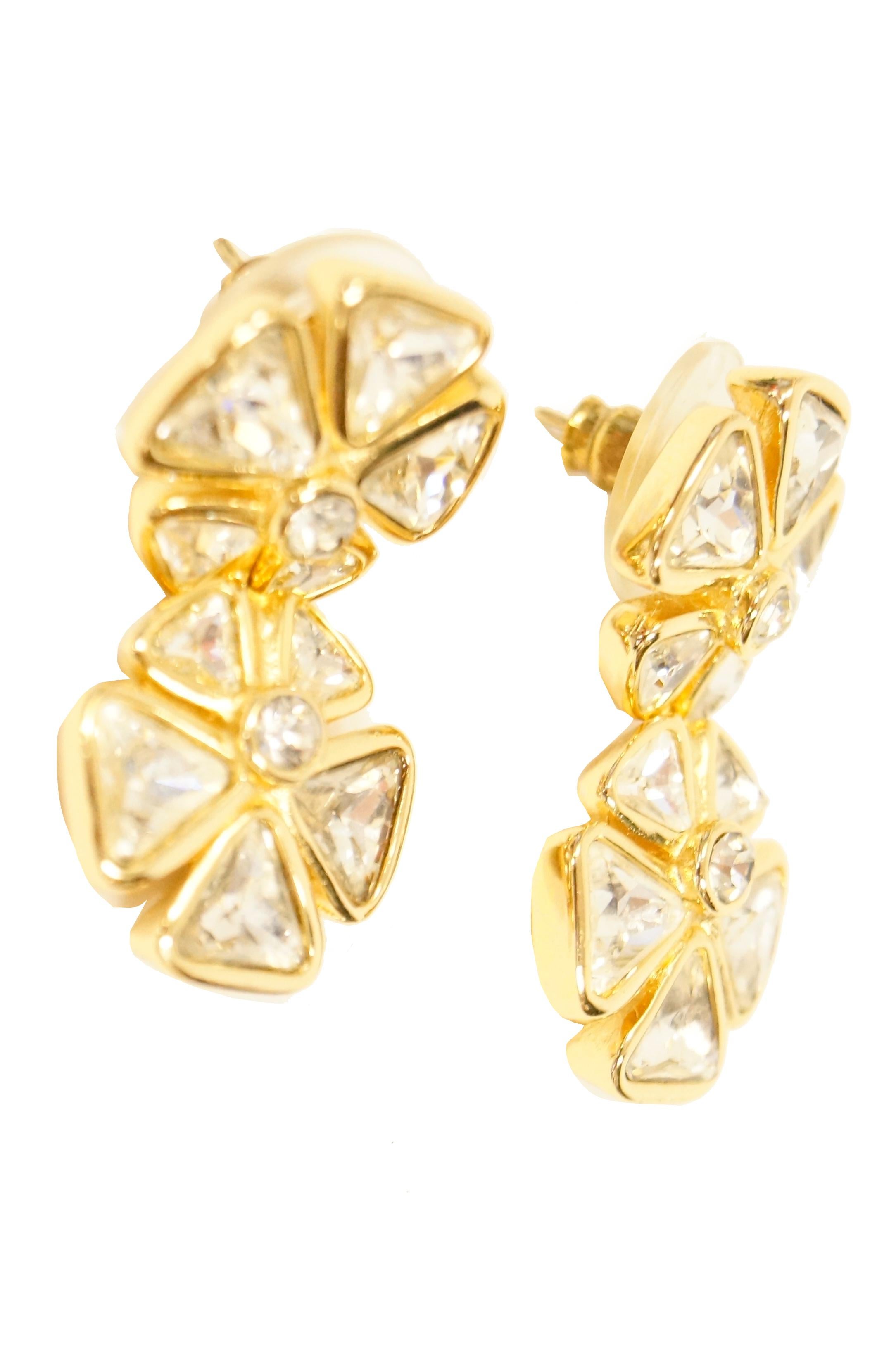 Delightfully cheery rhinestone earrings by Dior! Each earring features two five - petal flowers consisting of triangular rhinestones in a vermeil yellow gold bevel setting with a multifaceted circular rhinestone center. The flowers are identical,