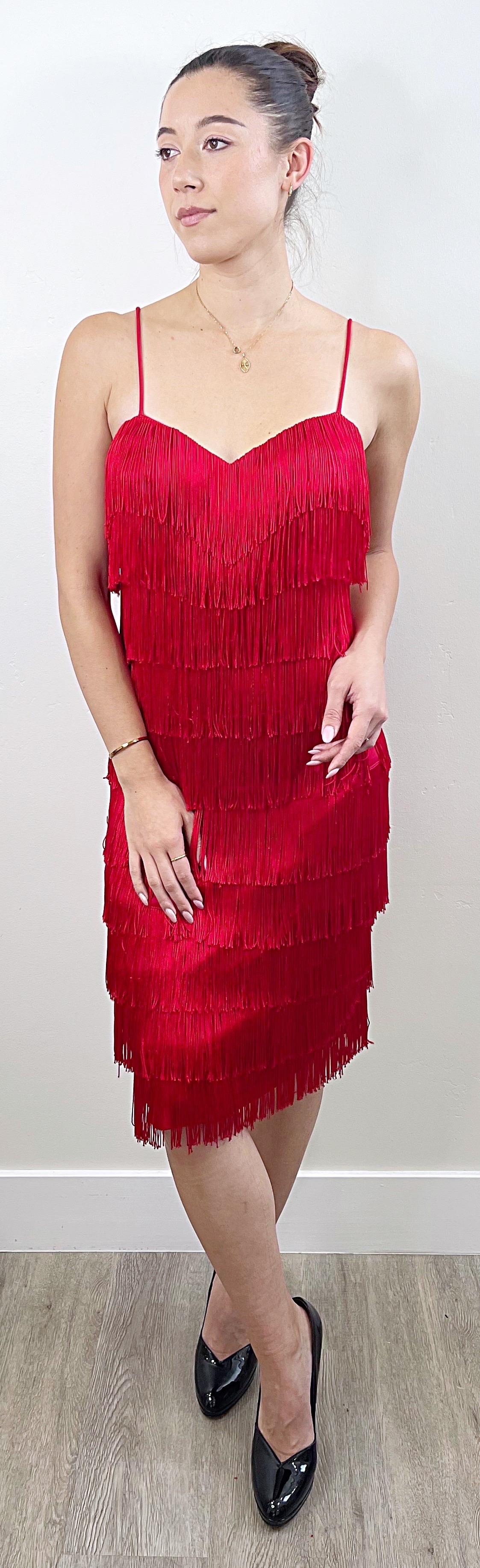 Incredible early 1980s does 1920s lipstick / cherry red fully fringed flapper style sleeveless dress ! Features nine tiers of fringe throughout the entire dress. Hidden zipper up the back. Stretch jersey stretches to fit.
Great for any day or