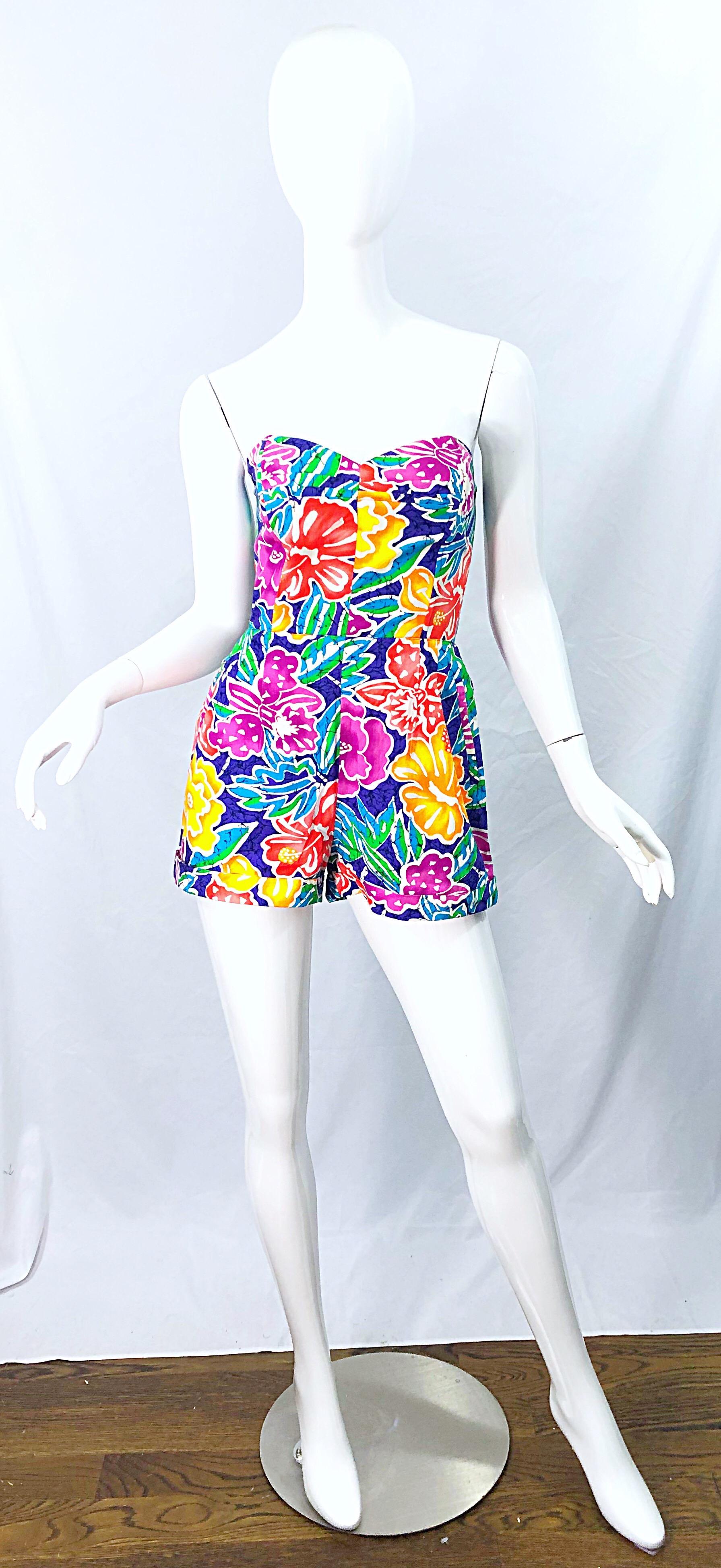 Chic 1980s does 1950s flower Hawaiian print strapless cotton romper / jumpsuit ! Features vibrant colors of purple, pink, yellow, green, orange, white and pink throughout. Pockets at each side of the hips. Boned bodice keeps everything in place.
